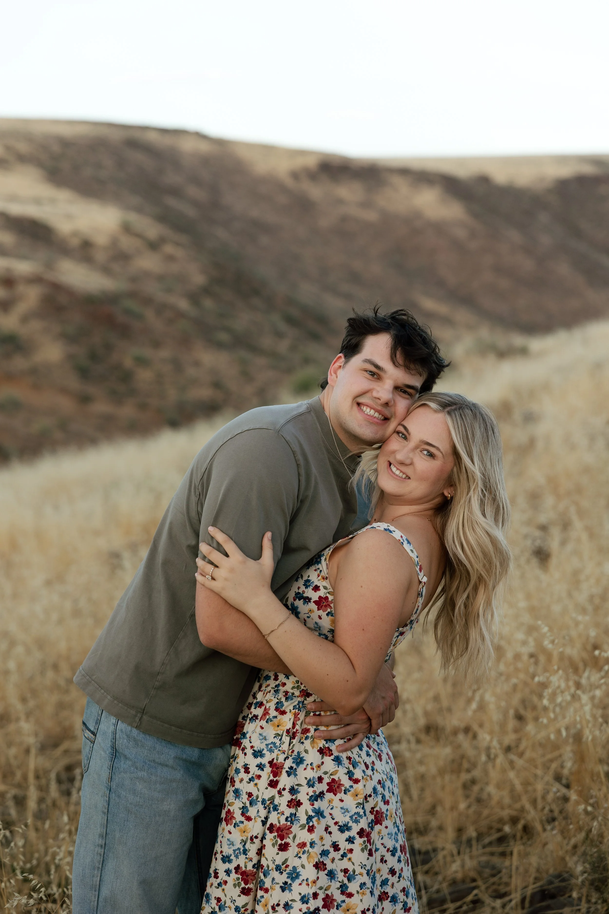 Arizona engagement photographer capturing a couple among golden grasslands at sunset