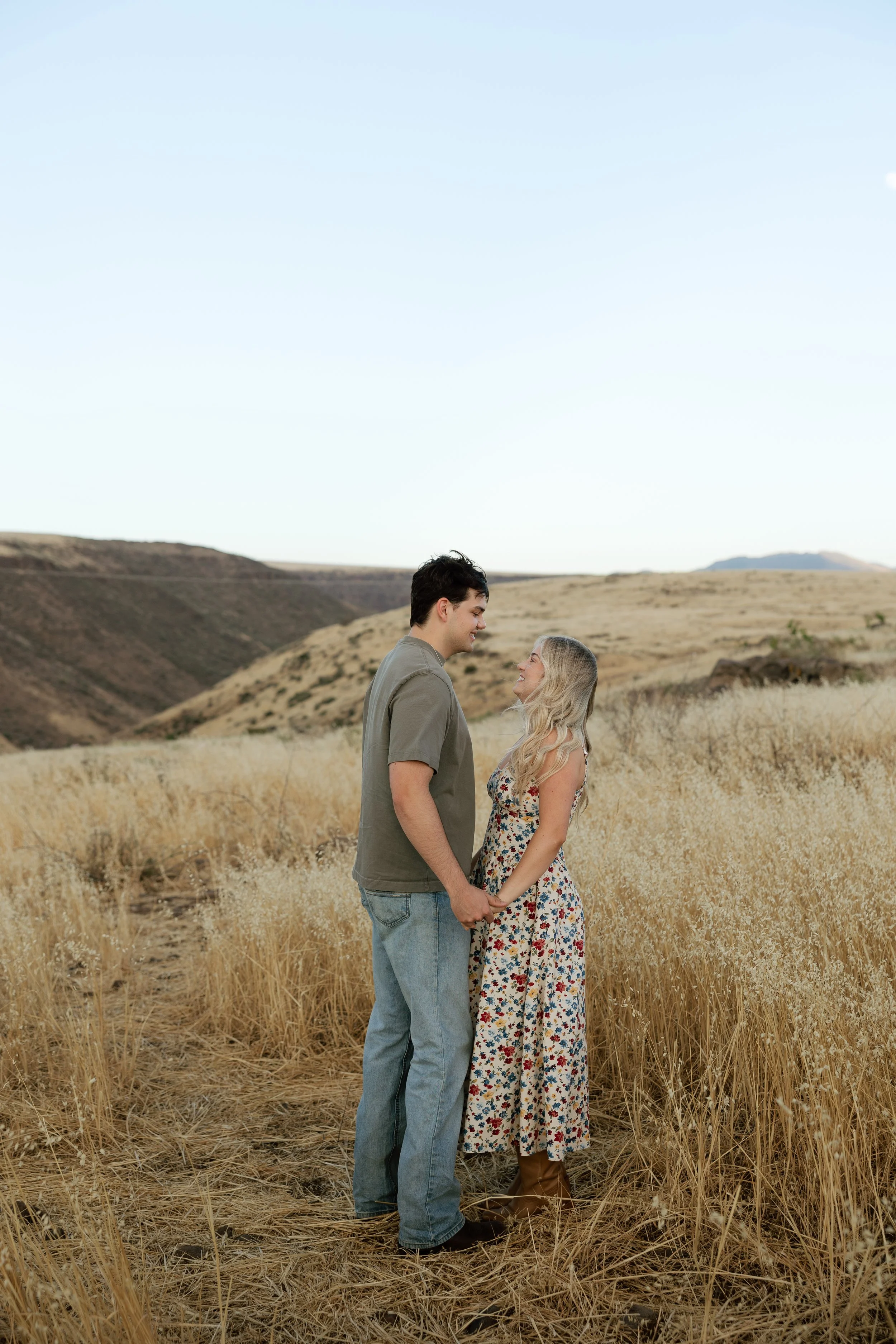 Romantic engagement portraits in the Arizona desert with rolling hills and soft evening light