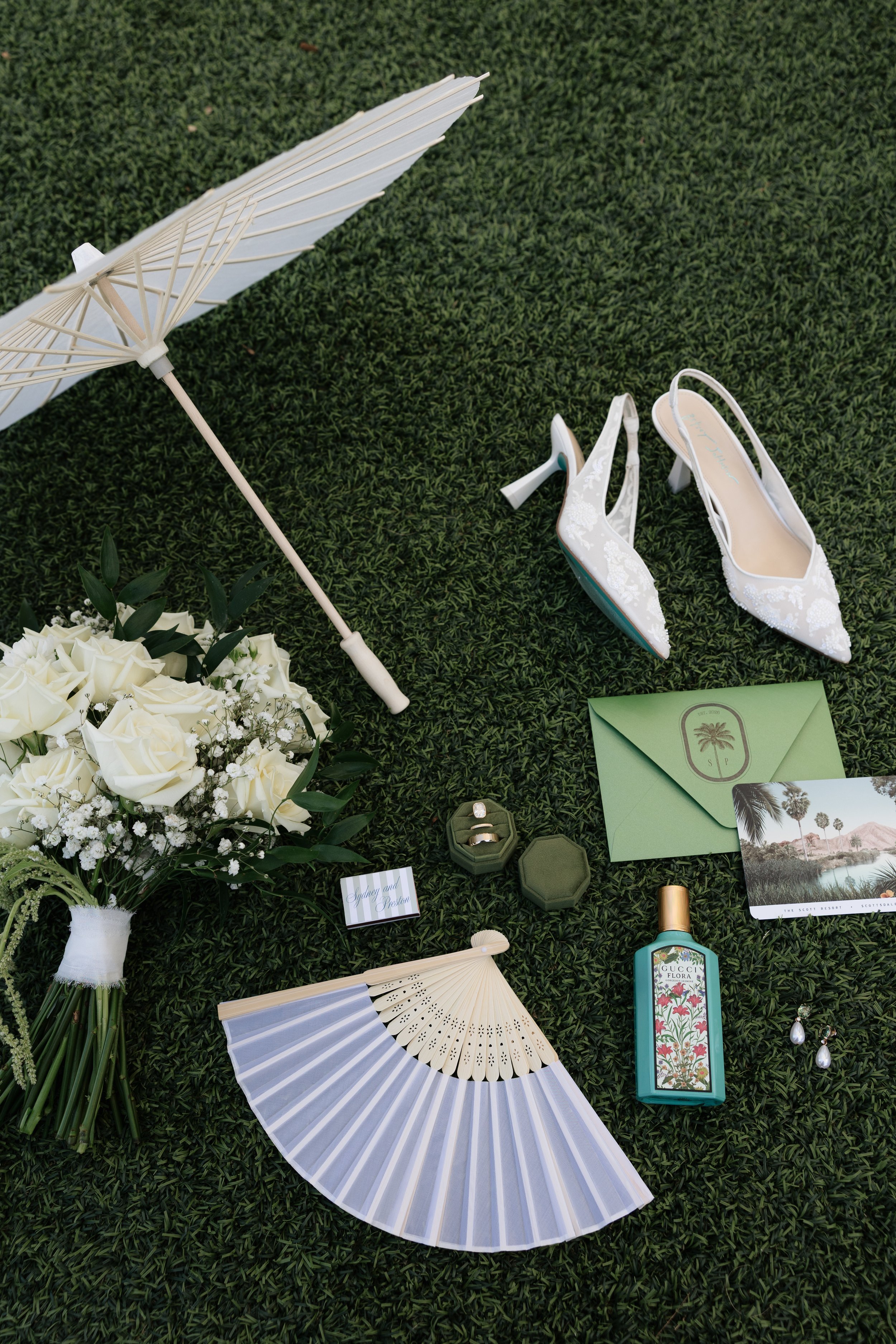 Wedding day details including invitation suite, rings, and accessories at The Scott Resort & Spa wedding in Scottsdale, Arizona