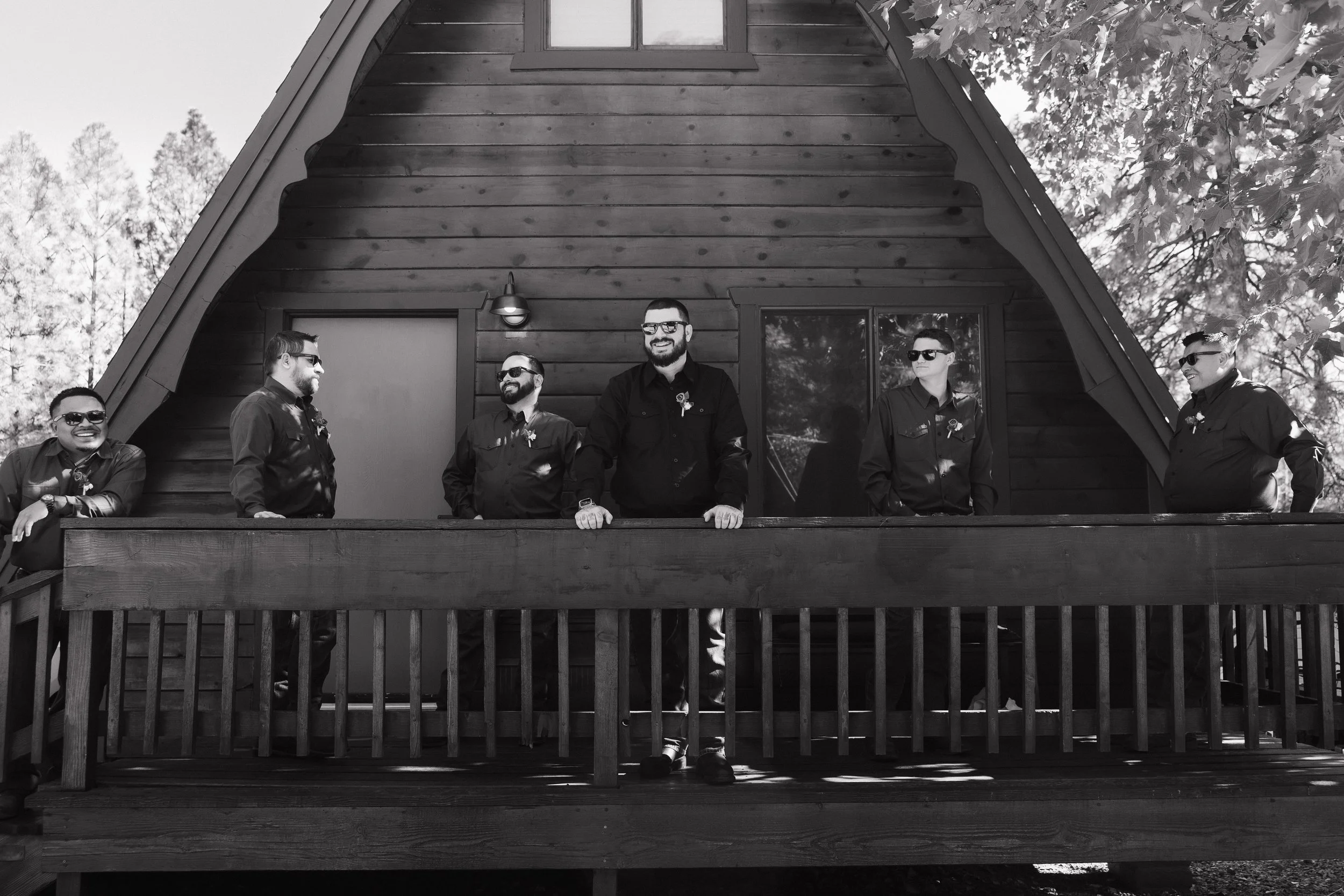 groomsmen on the porch of a cabin at cabins on strawberry hill