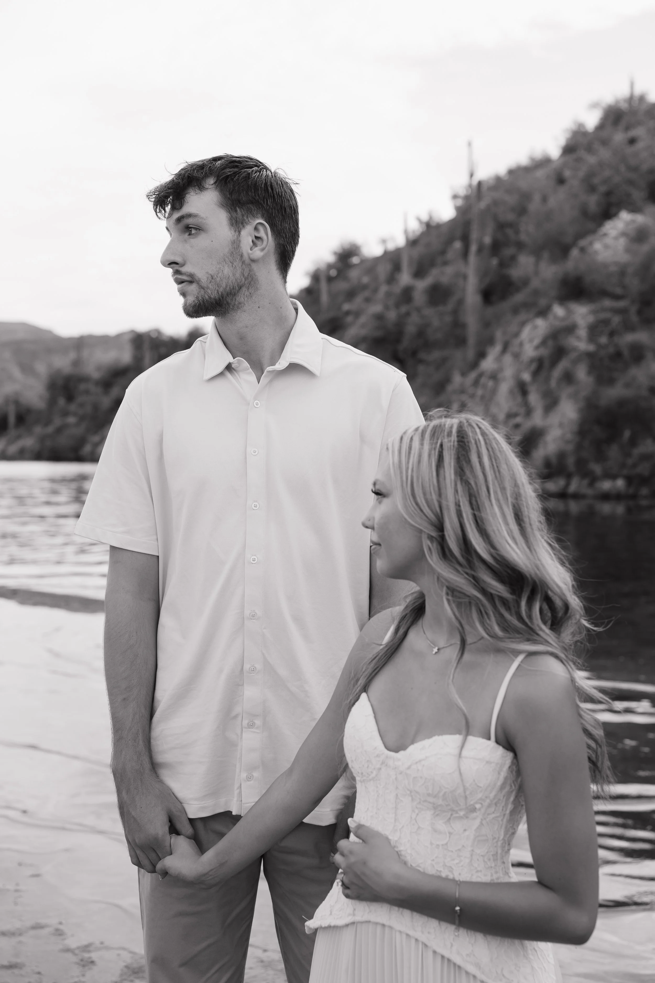 editorial engagement portraits with couple looking out at the lake in arizona at butcher jones
