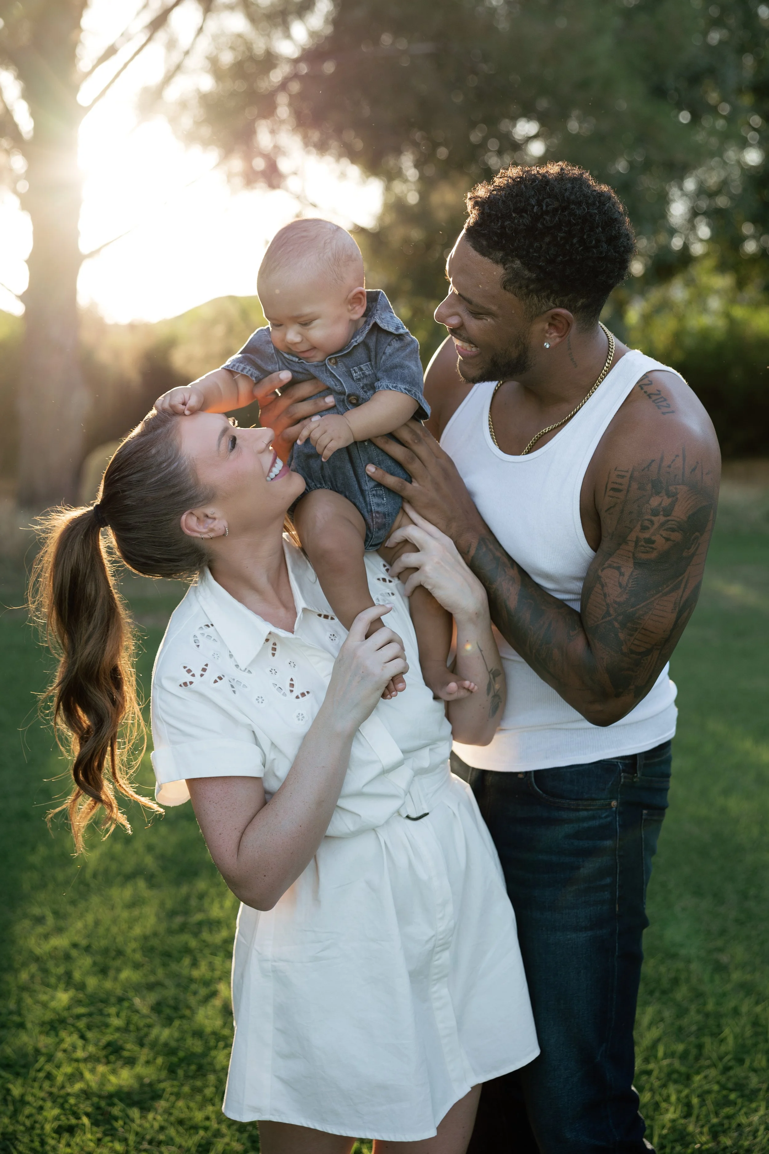 Young family sharing a candid moment together during a sunset portrait session in Arizona