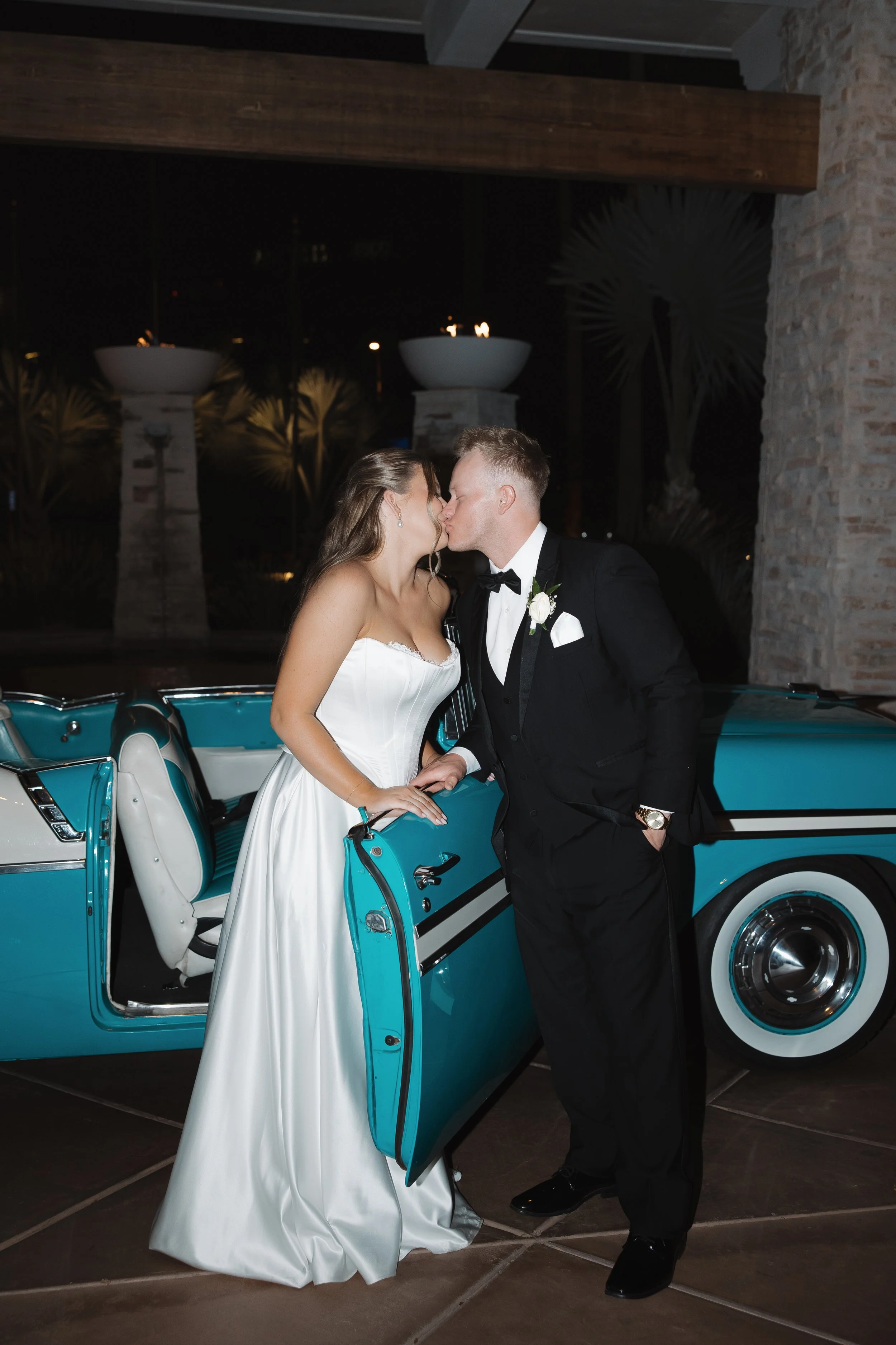 Late-night wedding portraits with vintage car outside The Canal Club at The Scott Resort & Spa in Scottsdale, Arizona