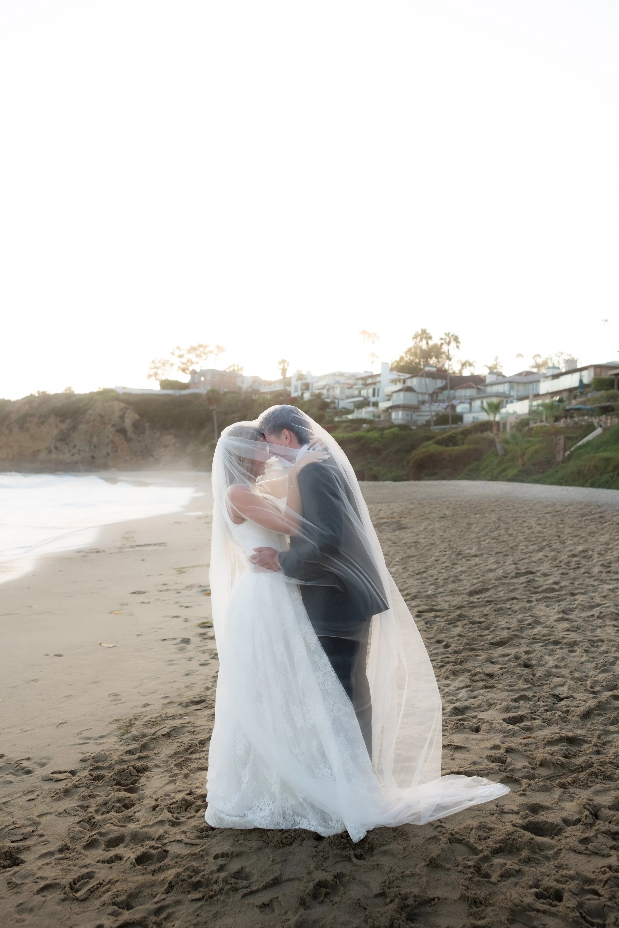 newlyweds under veil during their bridal portraits in southern california
