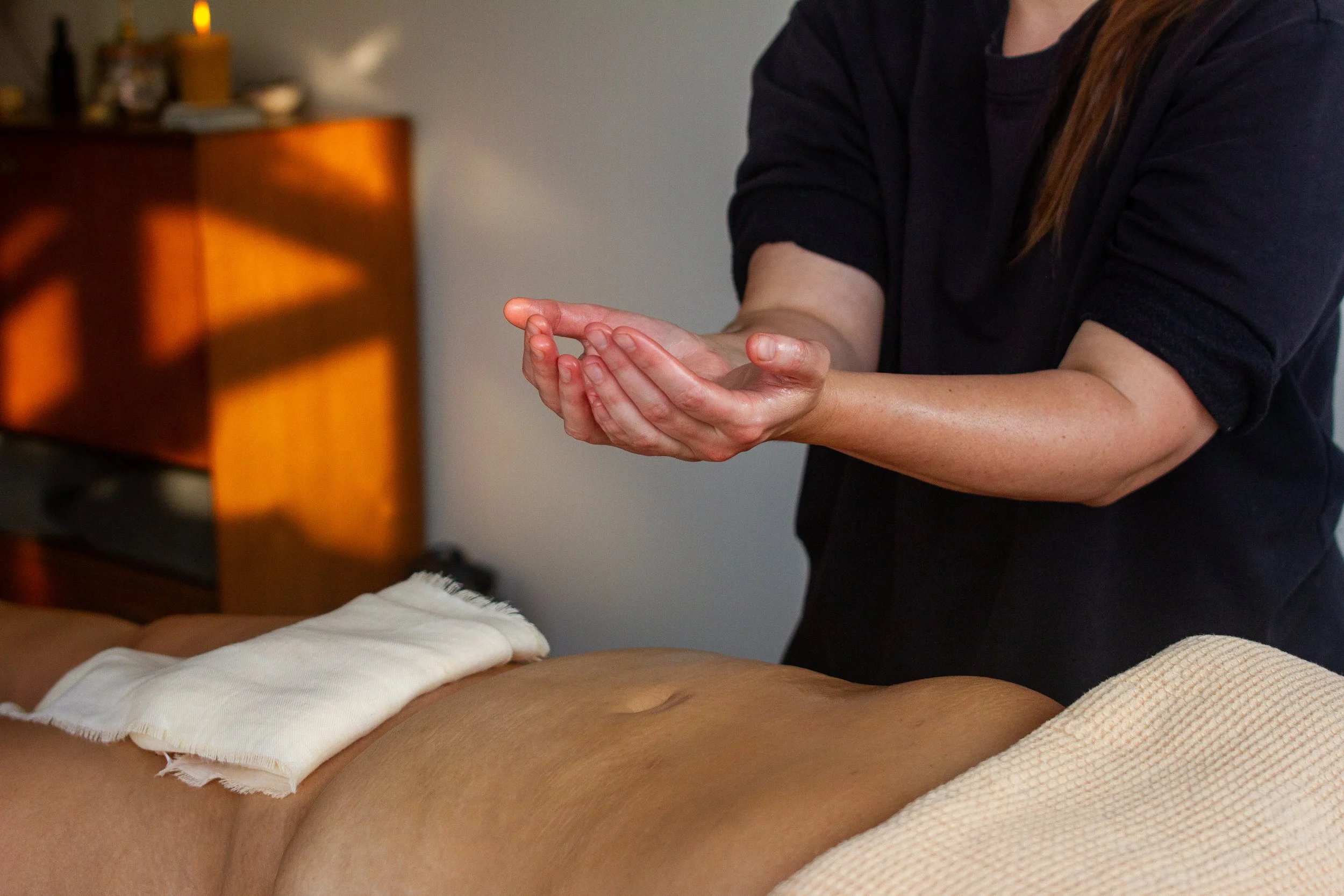 Buikmassage ritueel tijdens Lomi Lomi sessie.