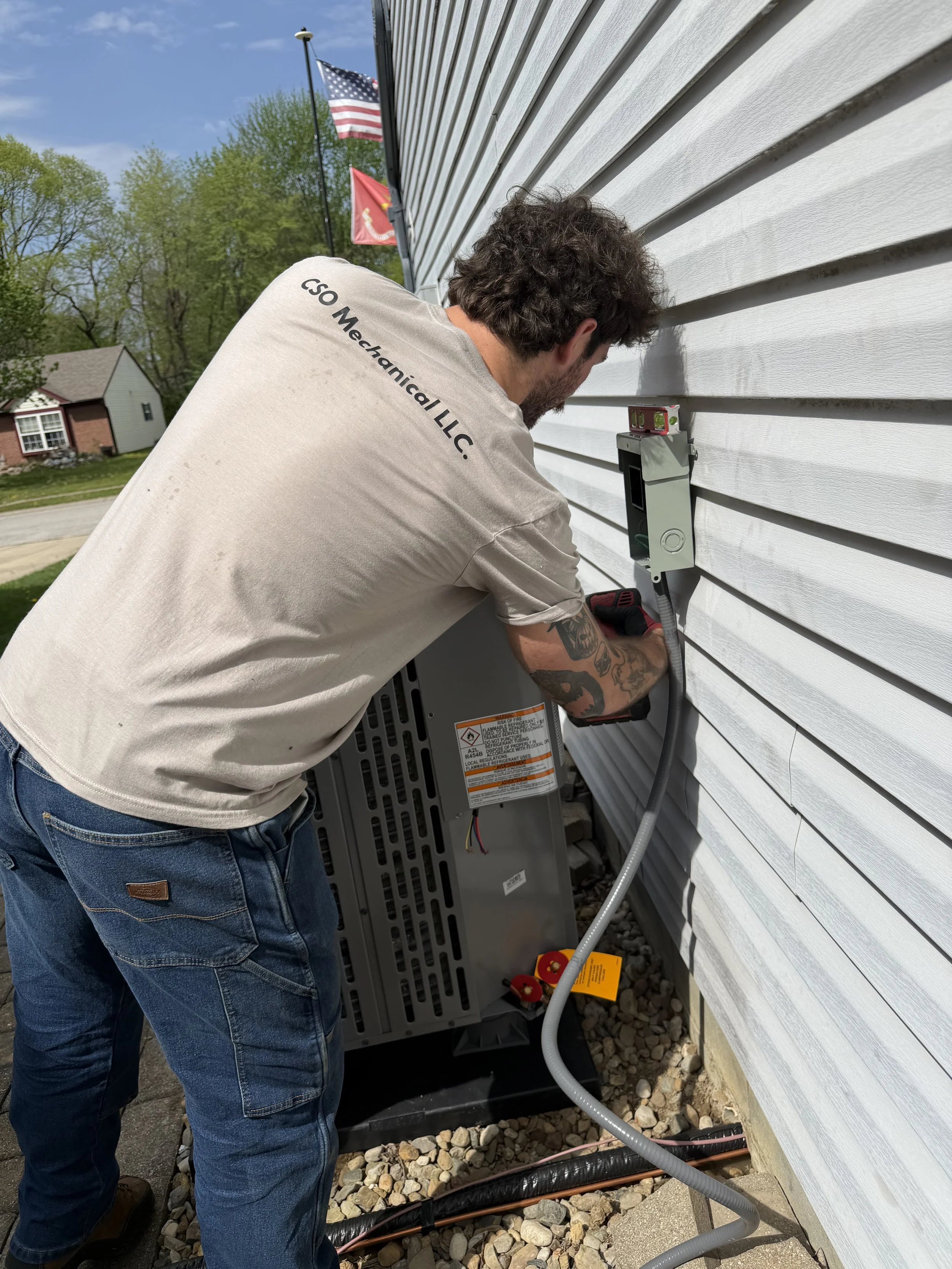 HVAC technician installing an air conditioning unit.