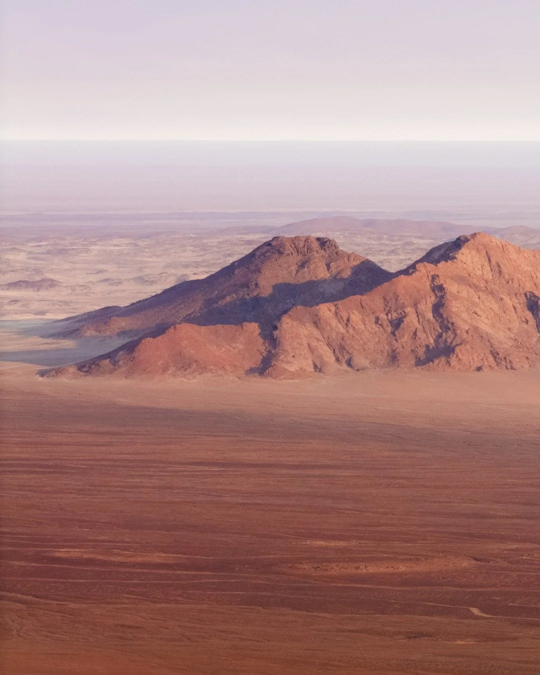𝗠𝗘𝗦𝗦𝗨𝗠 𝗖𝗥𝗔𝗧𝗘𝗥 | We&rsquo;ve camped inside a few craters before, and Messum Crater did not disappoint! Tucked deep in the Namib Desert, it stretches about 18 km across - a massive geological basin formed roughly 130 million years ago durin
