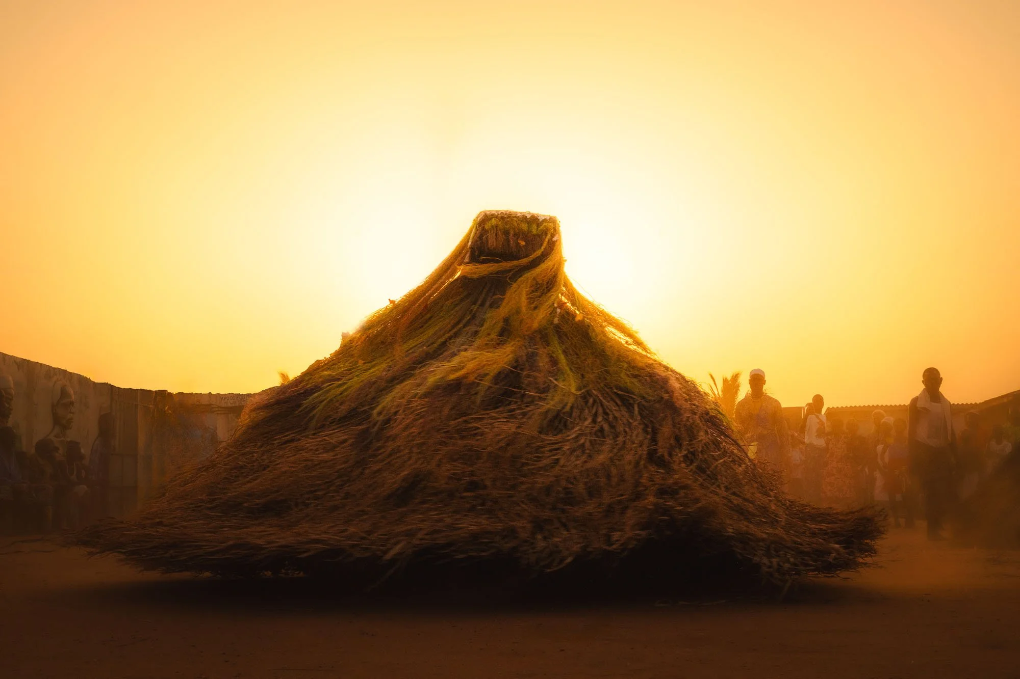 Visual Ethnographer Cliff Fawcett captures a Zangbeto Voodoo guardian spinning in Benin. This high-arousal action shot illustrates the grit required to move past the tourist gaze.