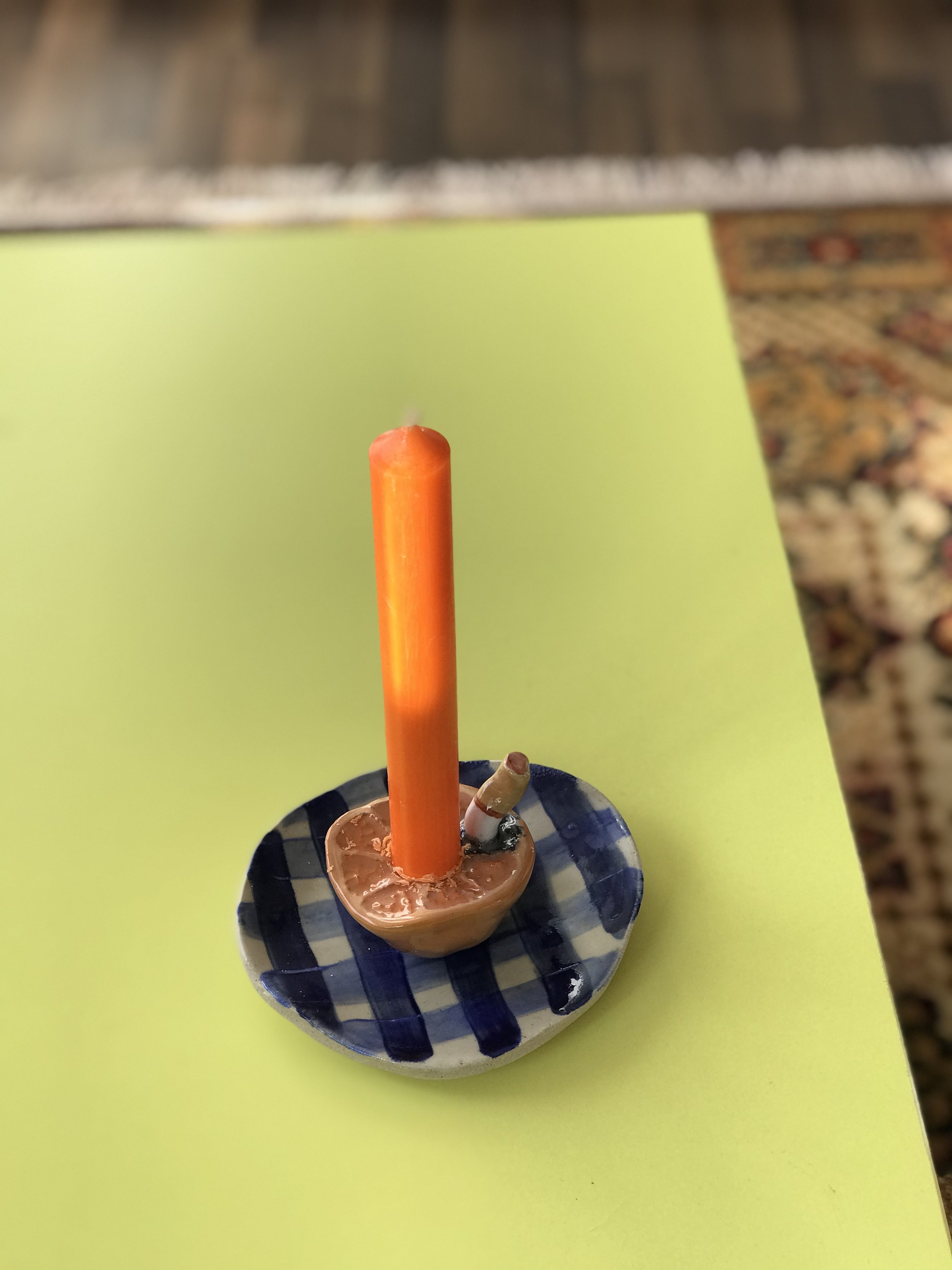 Orange on a Plate with Cigarette Candle Holder