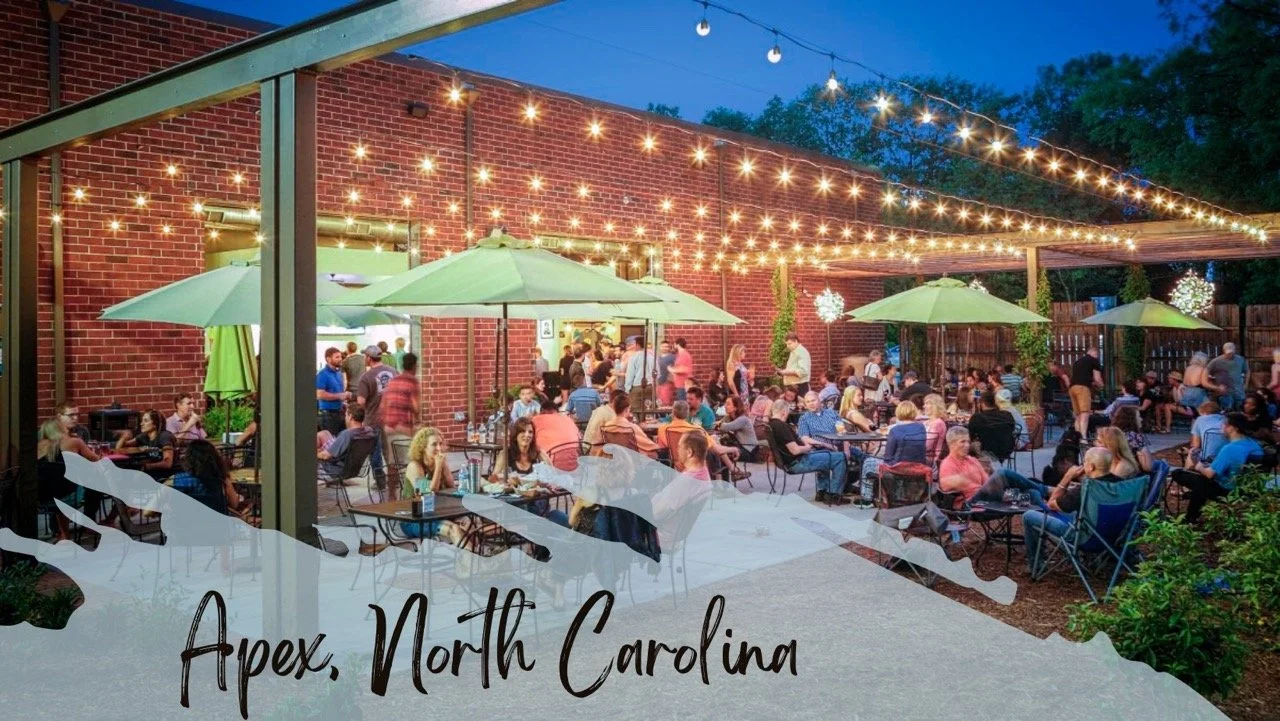An outdoor seating area filled with people with a text overlay saying "Apex, North Carolina"
