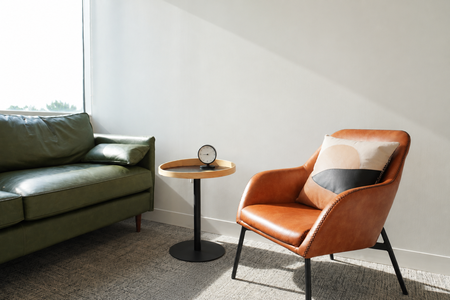 Green leather sofa, orange/brown leather chair  in therapy office