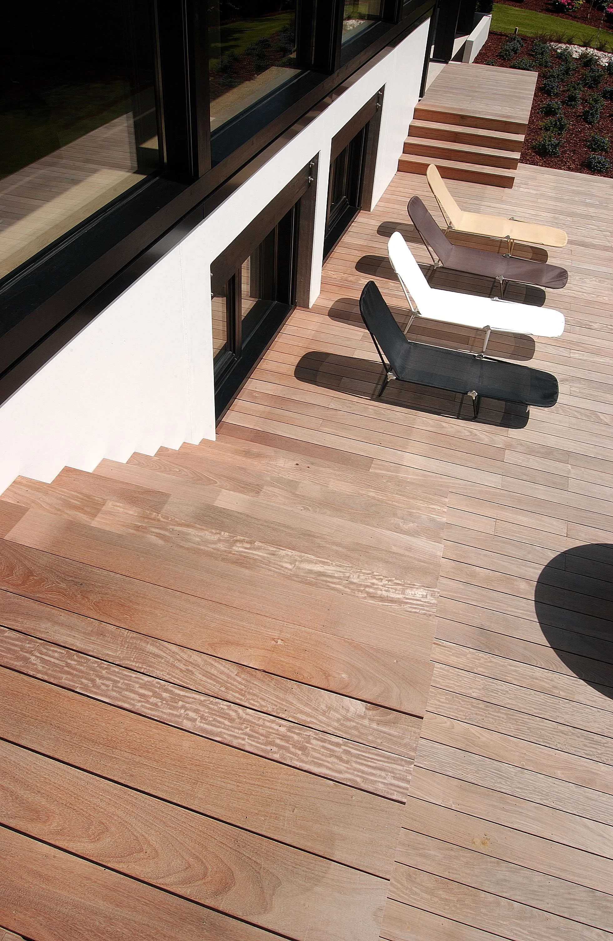 contemporary garden with sun loungers on decking