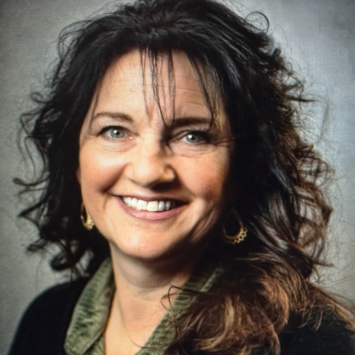 Jullie Love of The Well Coffee House, a woman with curly dark hair and blue eyes.