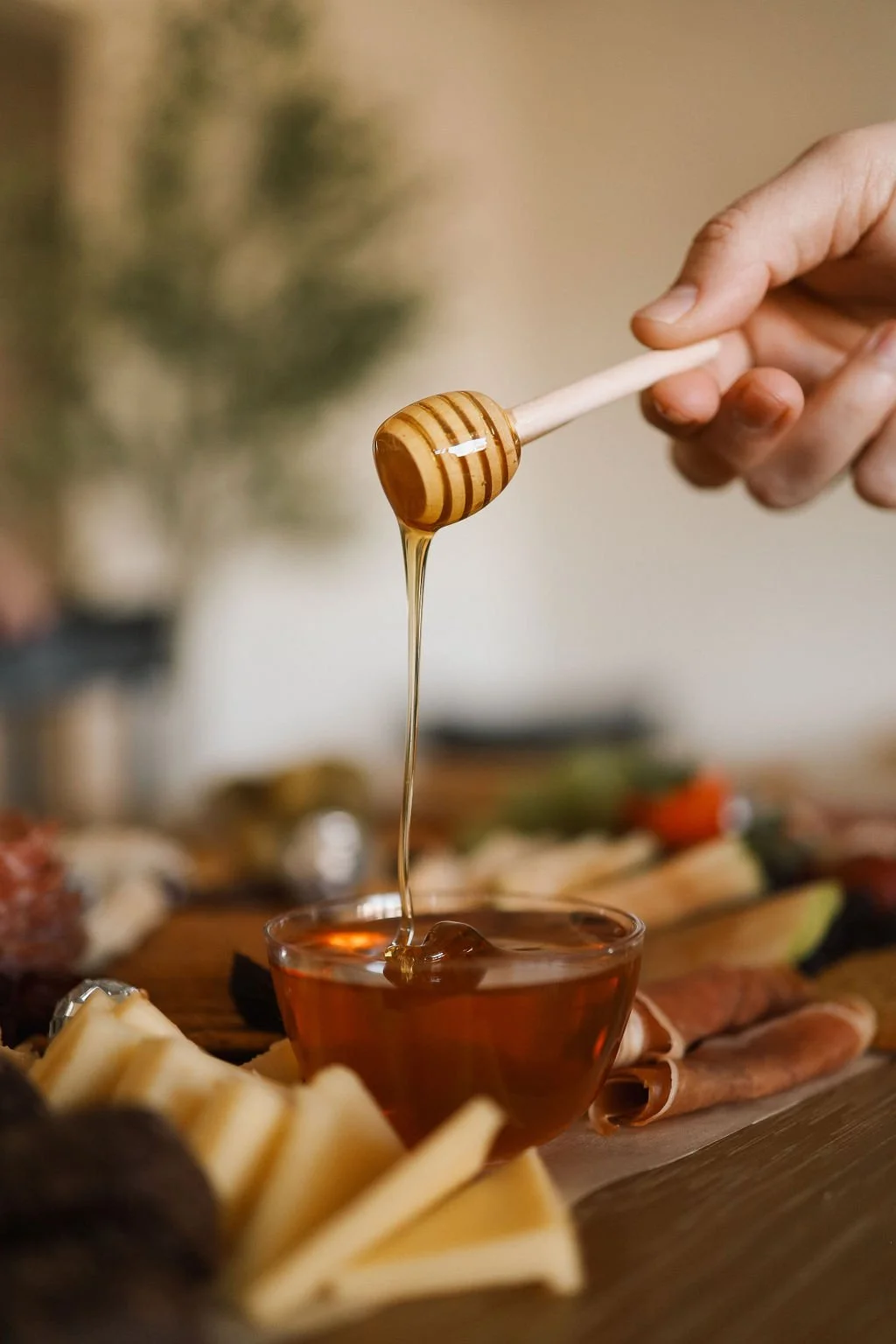 honey dripping on a charcuterie board
