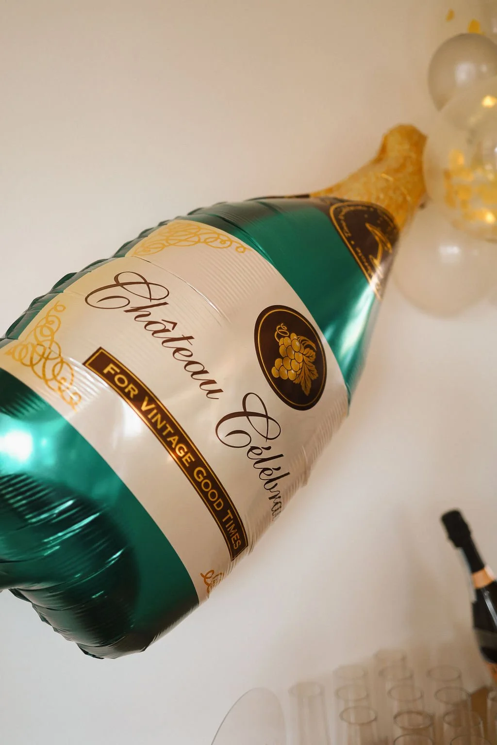 a green and gold champagne balloon