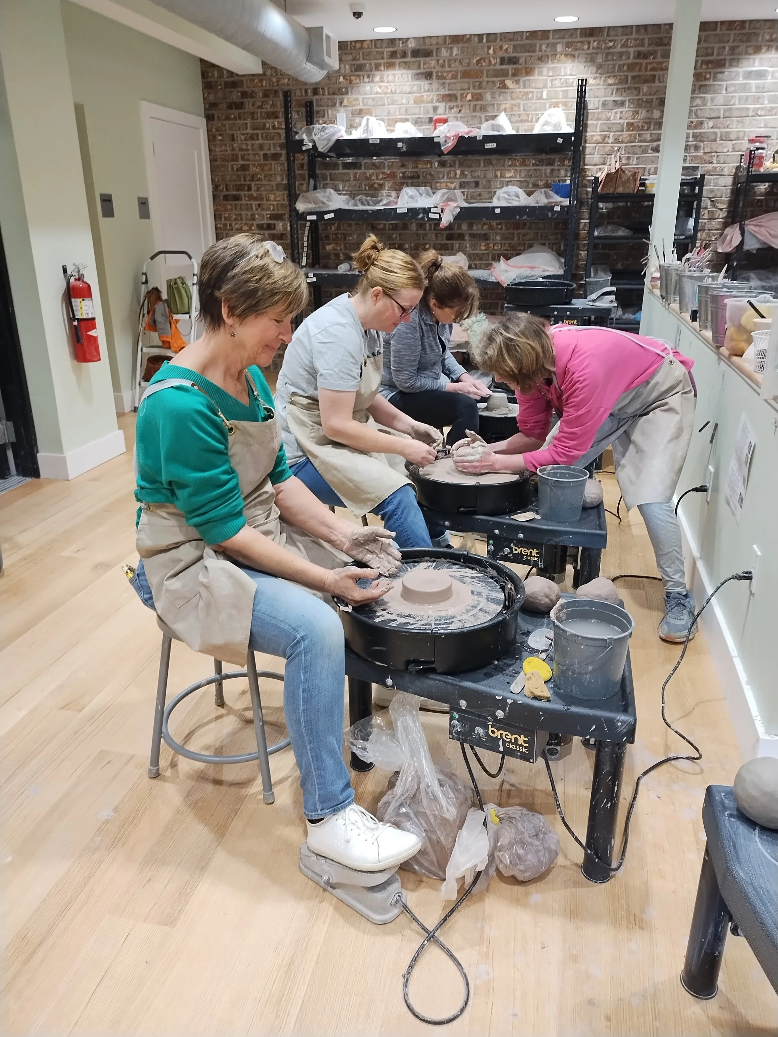 pottery instructor helping students