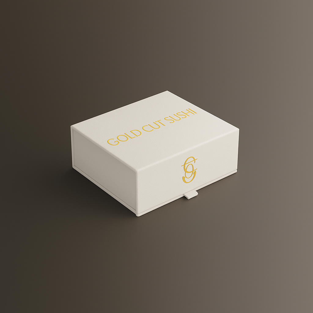 White box with gold text that reads 'GOLD CUT SUSHI' and a gold monogram logo on the side, placed on a neutral gray surface.