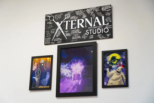 Wall with framed artwork and "Xternal Studio" sign located in clovis
