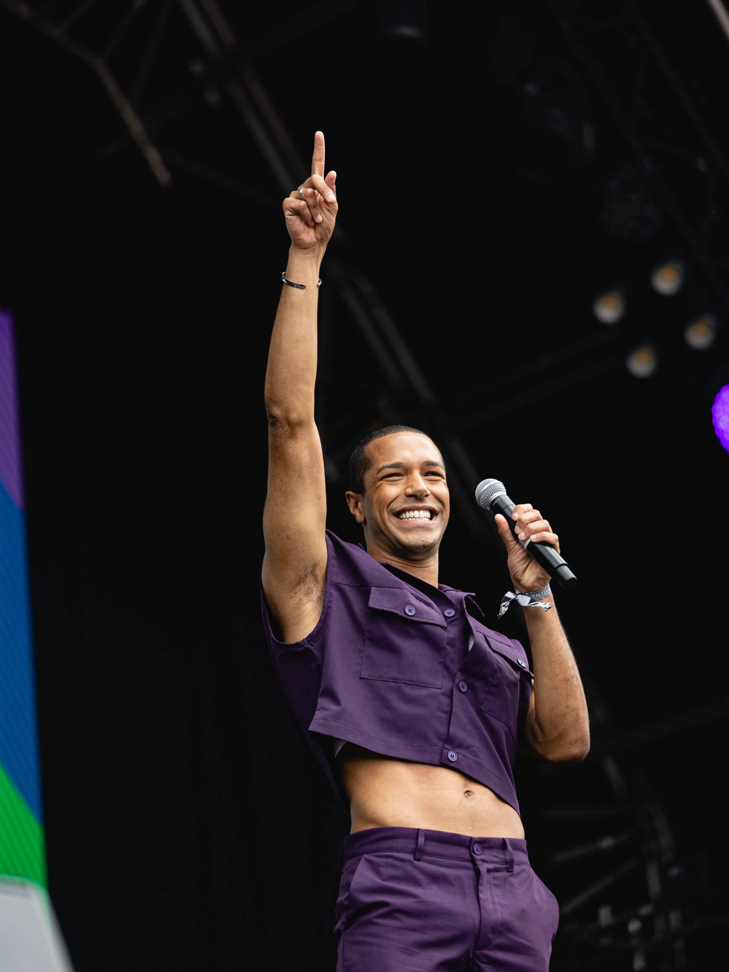 Michael Gunning (Host) on the Main Stage with a microphone in Trafalgar Square for Pride in London.
