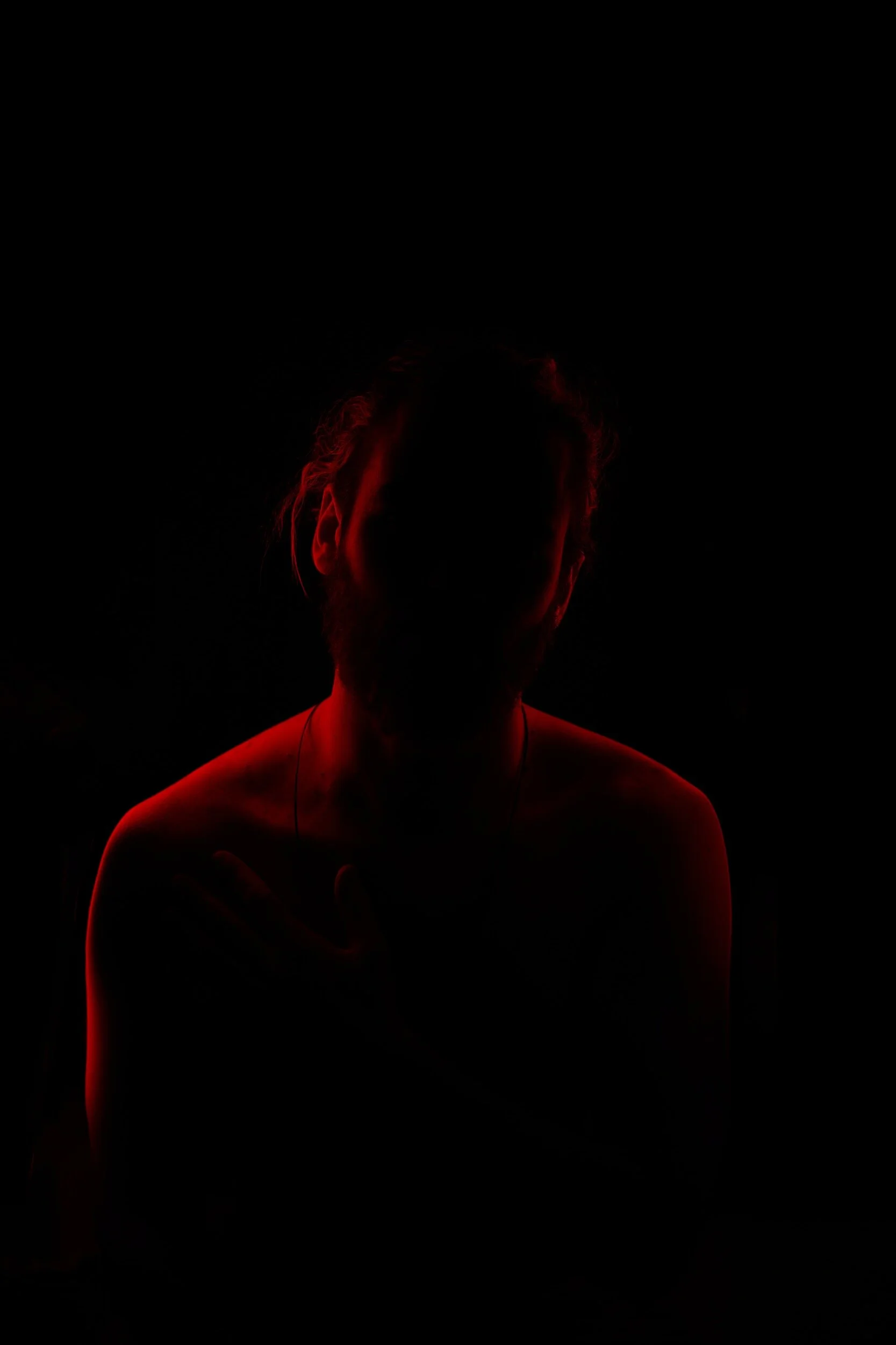 Red outline of man in shadows