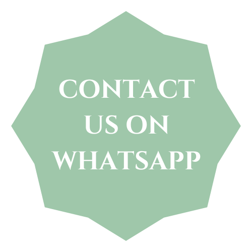 A badge-shaped sign with a light green background and white border, displaying the message: 'CONTACT US ON WHATSAPP'.