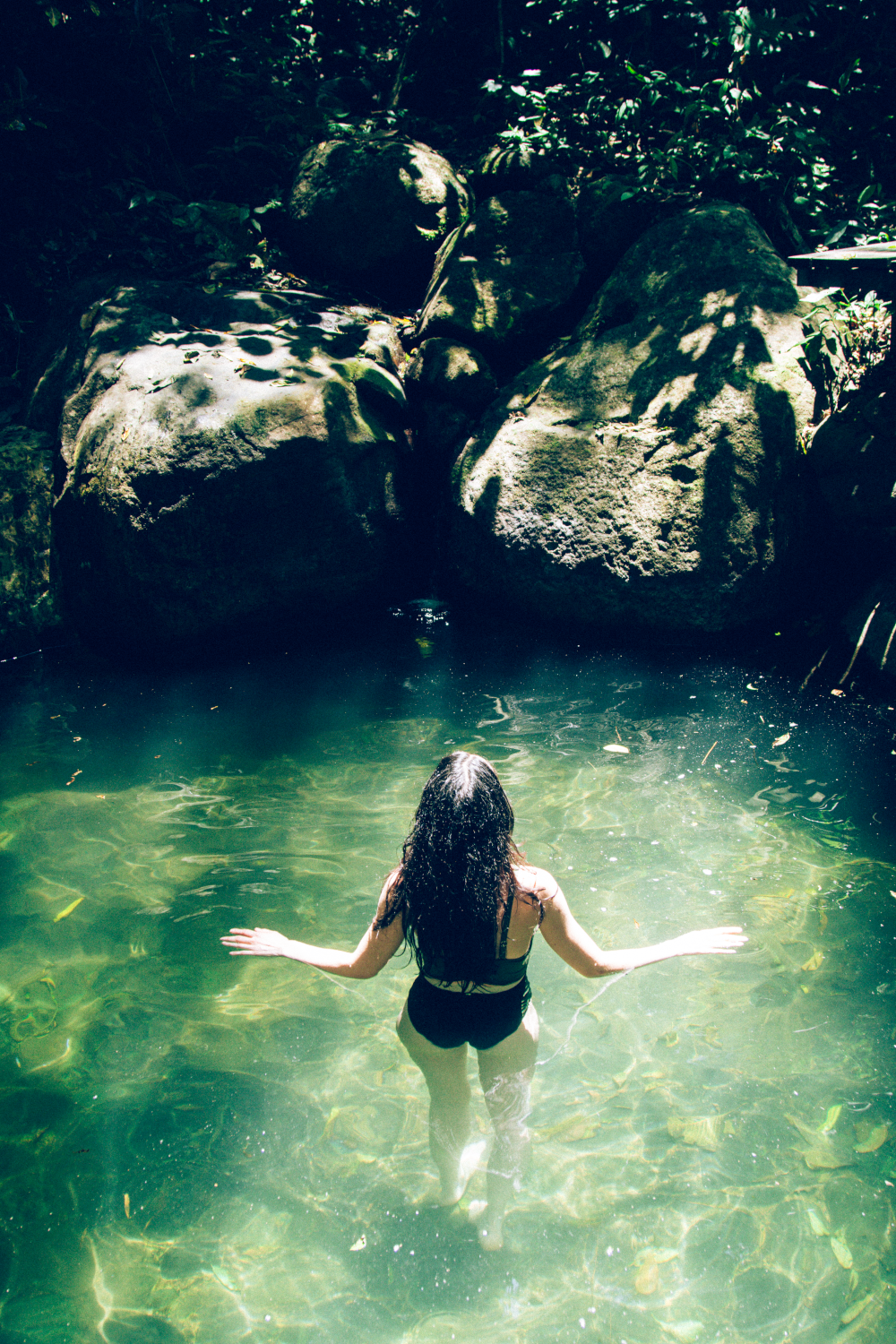 woman in natural swimming pool at Costa Rica retreat