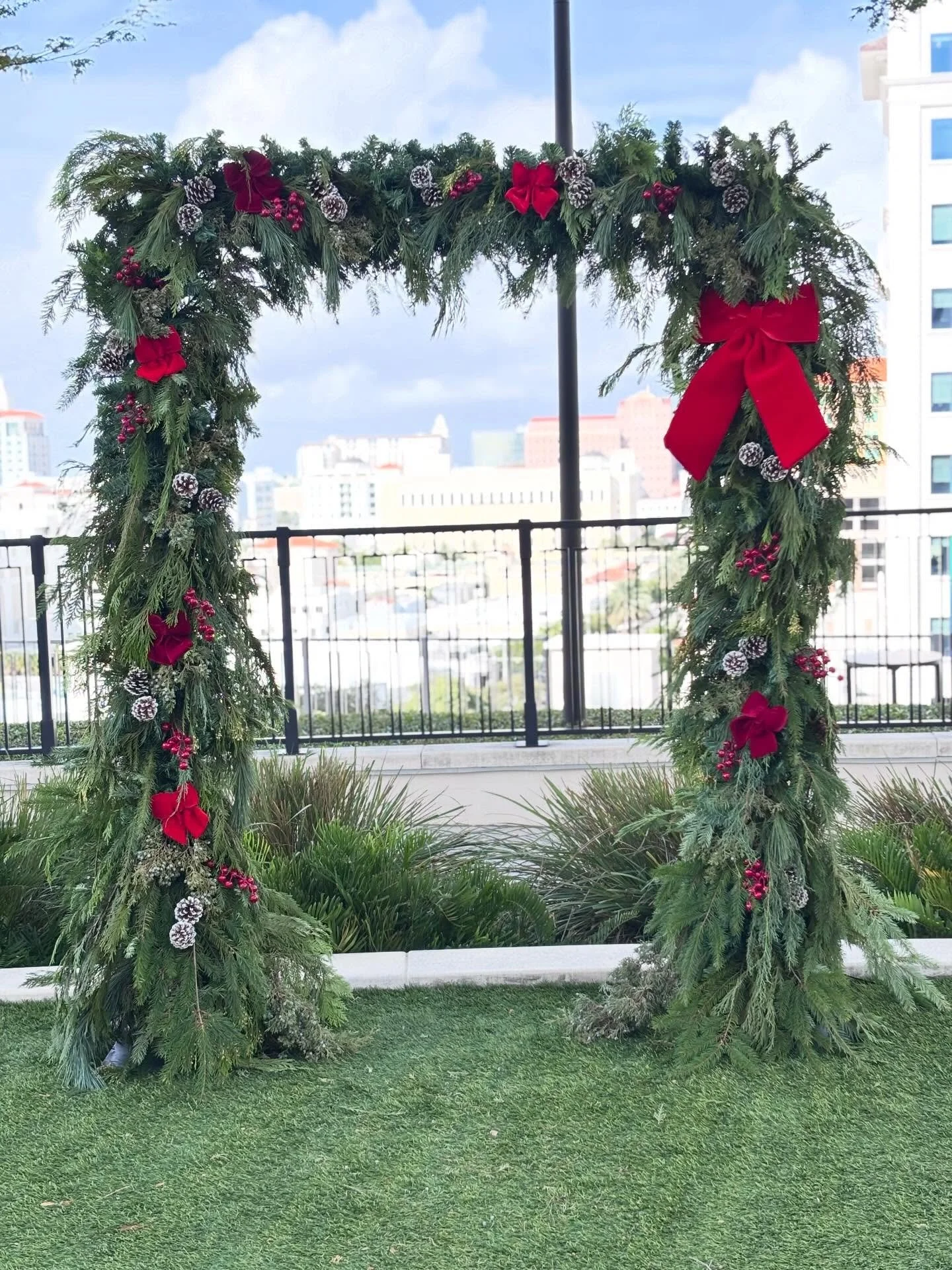 A pine arch adorned with pinecones, red bows, and berries &mdash; a refined corporate welcome.🎄🌲#CorporateEvent
#HolidayDecor
#FestiveDesign
#PineArch
#HolidayStyling
ChristmasDecor
