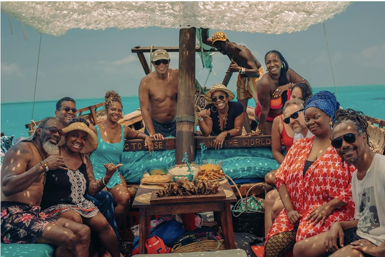 EARTHCANDY ARTS rē retreat guests celebrating on the turquoise waters of Zanzibar during JAMILA CRAWFORD PÉCOU'S curated luxury travel experience.