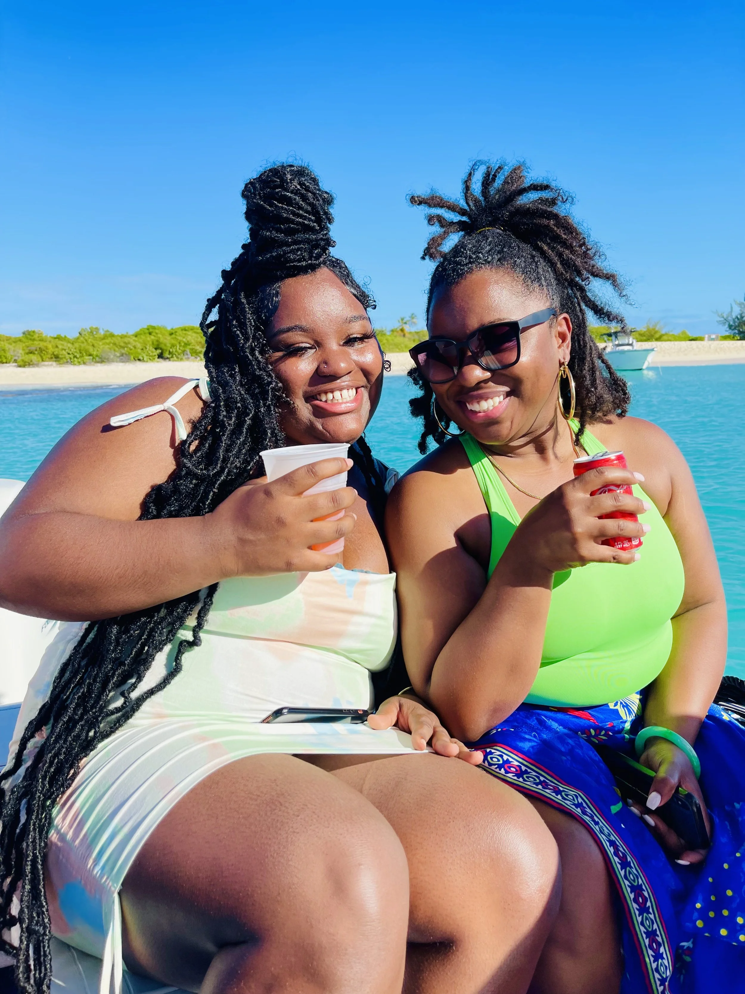A mother and daughter enjoy a sunny boat cruise in Puerto Rico during an EARTHCANDY TRAVELS experience curated by Jamila Crawford Pécou, sharing tropical views, laughter, and meaningful moments together on the water.