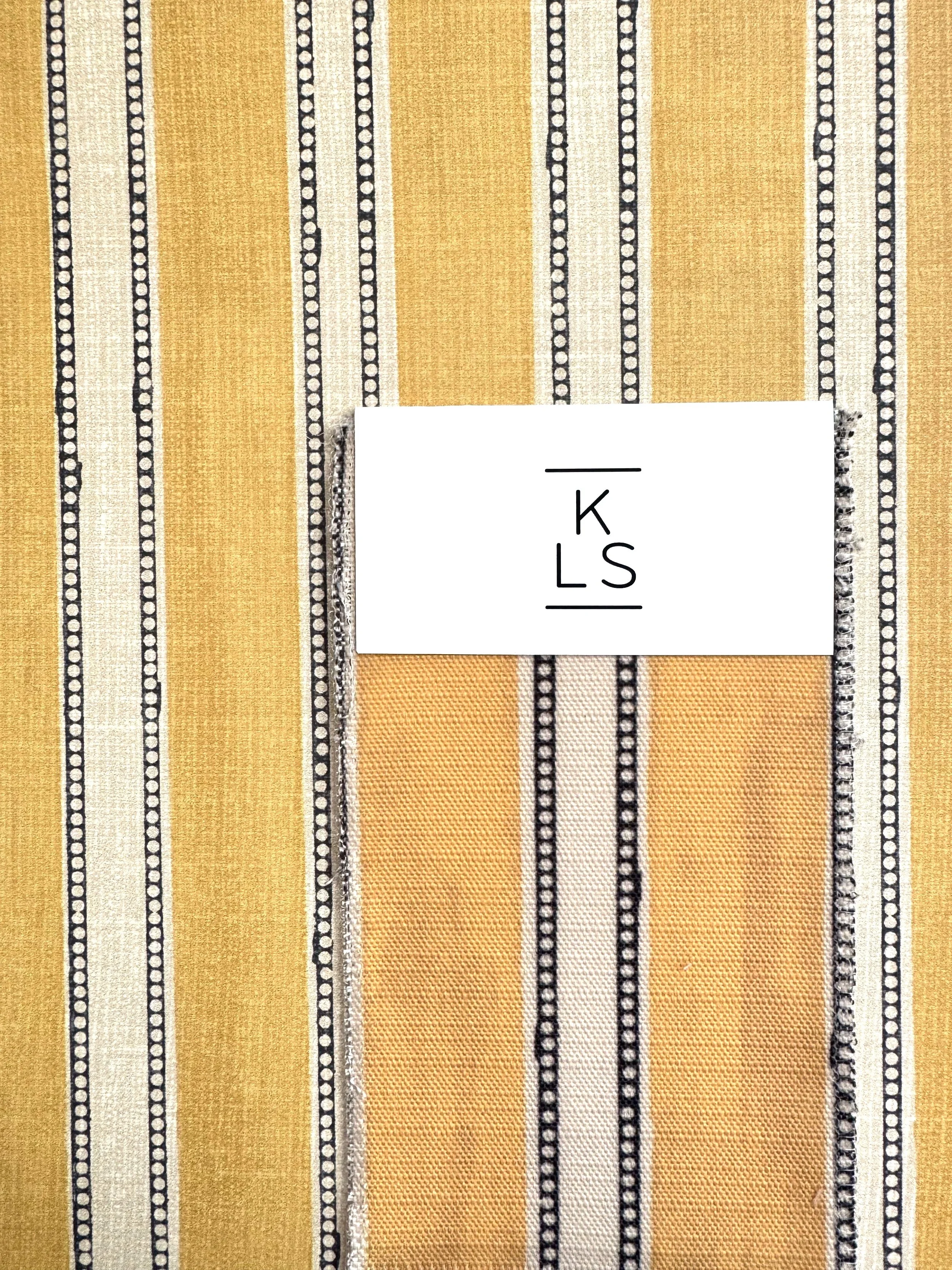 THE EDWARDIAN IN OCHRE is also available as a fabric.  
Kate combined a classic French silk stripe with a childhood memory – the hole-punched printouts from an old telex machine in her father’s office – to create this robust, masculine design. His lo