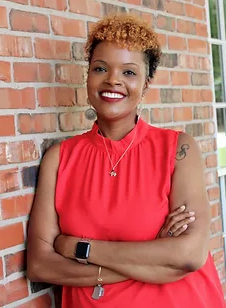 A woman smiles and wears a red shirt.