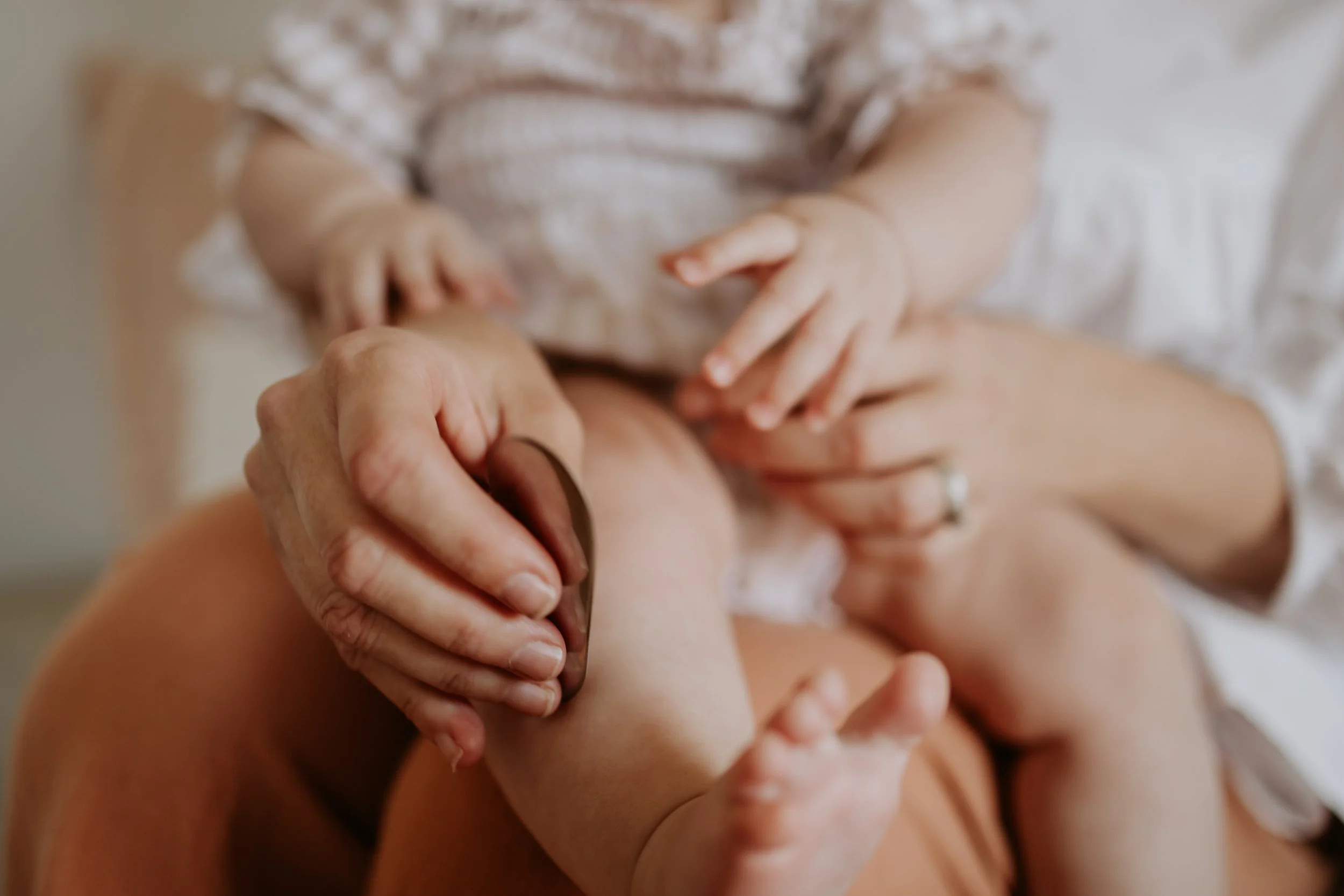 An infant client receiving a shonishin treatment