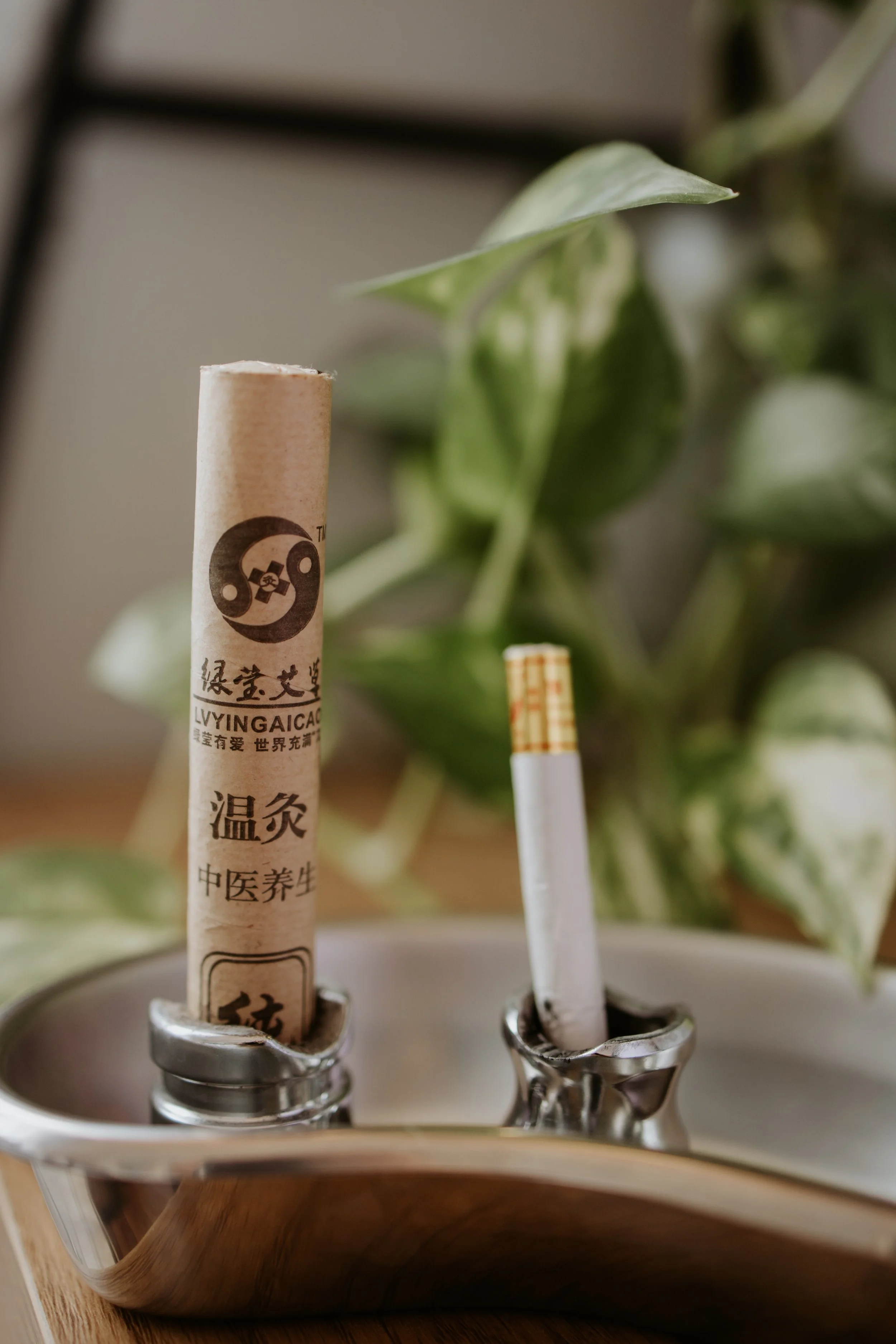 A photograph of 2 sticks of moxa used for moxibustion