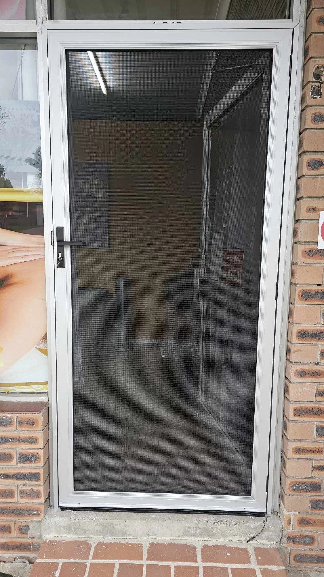 security screen door on local business