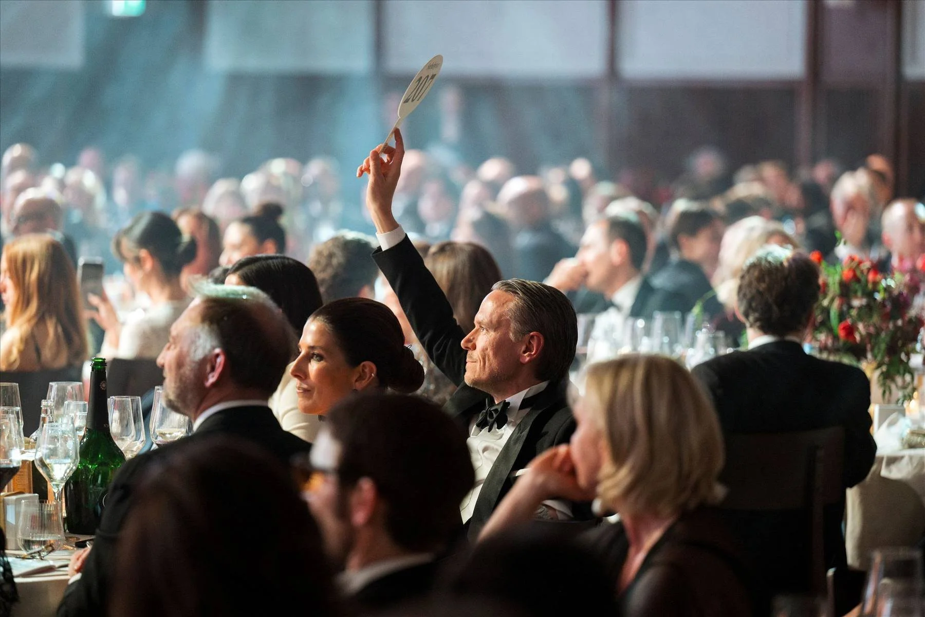 Guests at The King’s Trust gala dinner raising auction paddles