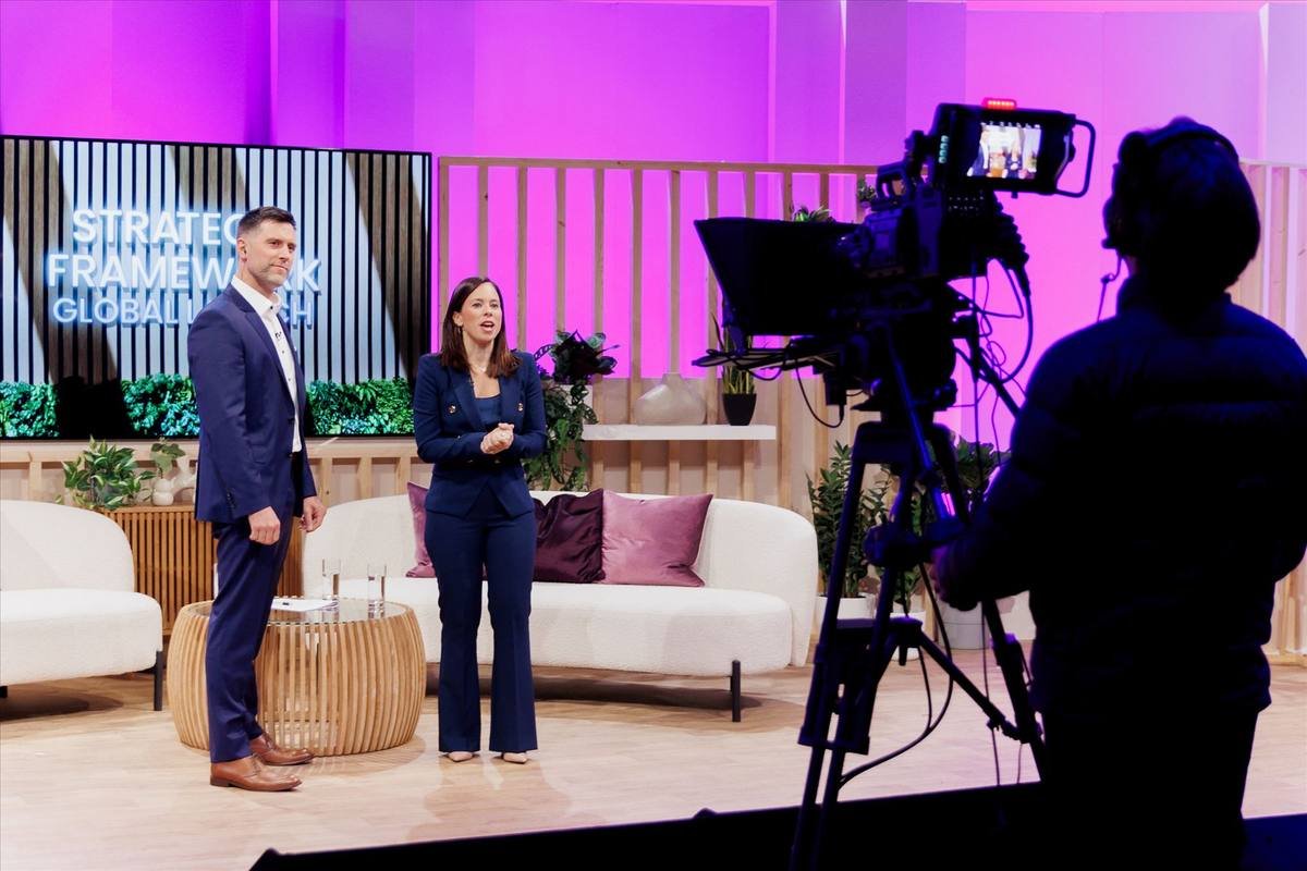 aCamera operator filming presenters on set