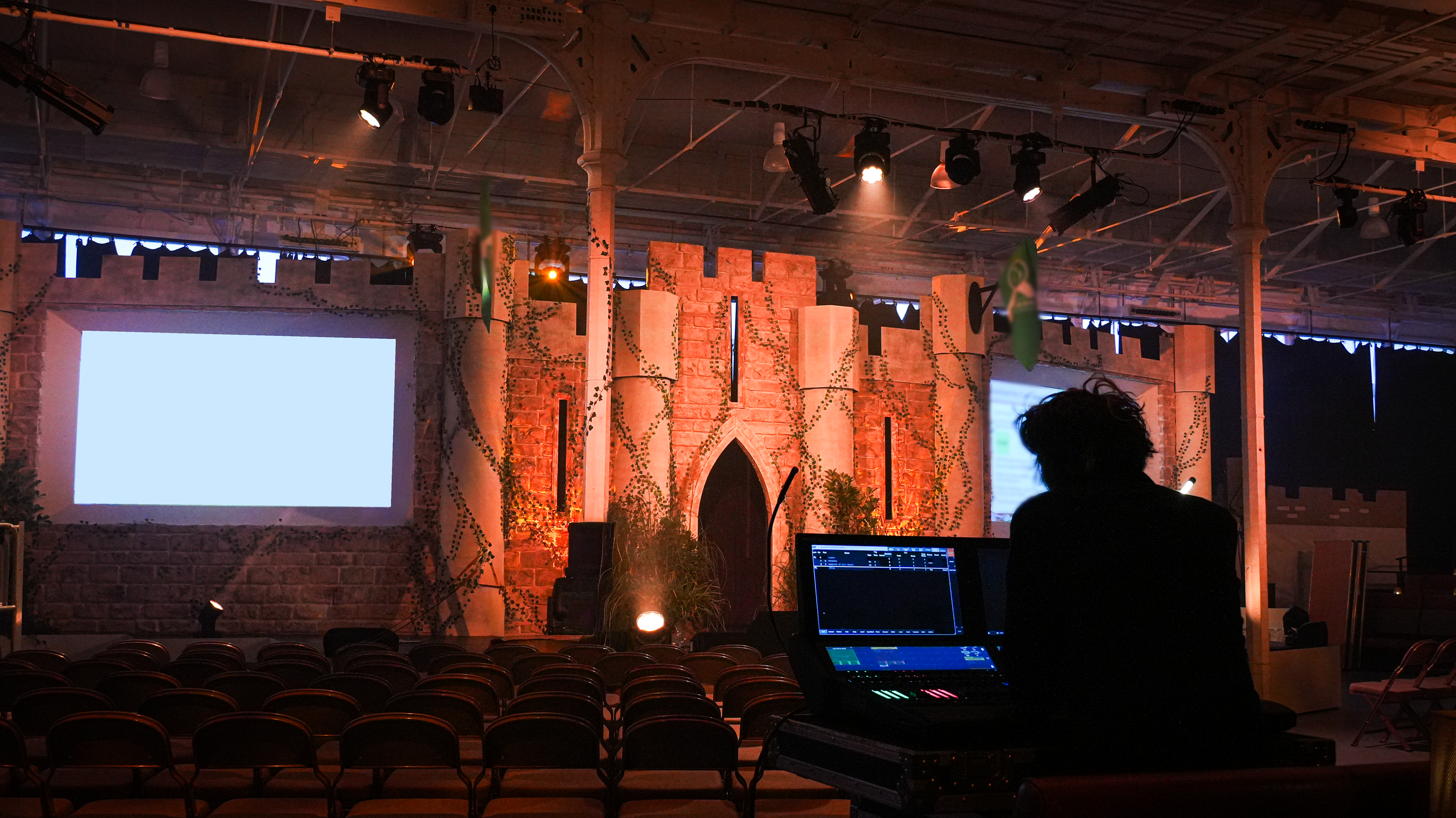 Castle-themed conference set with stone-effect walls, turrets and a central screen, with a control position in the foreground