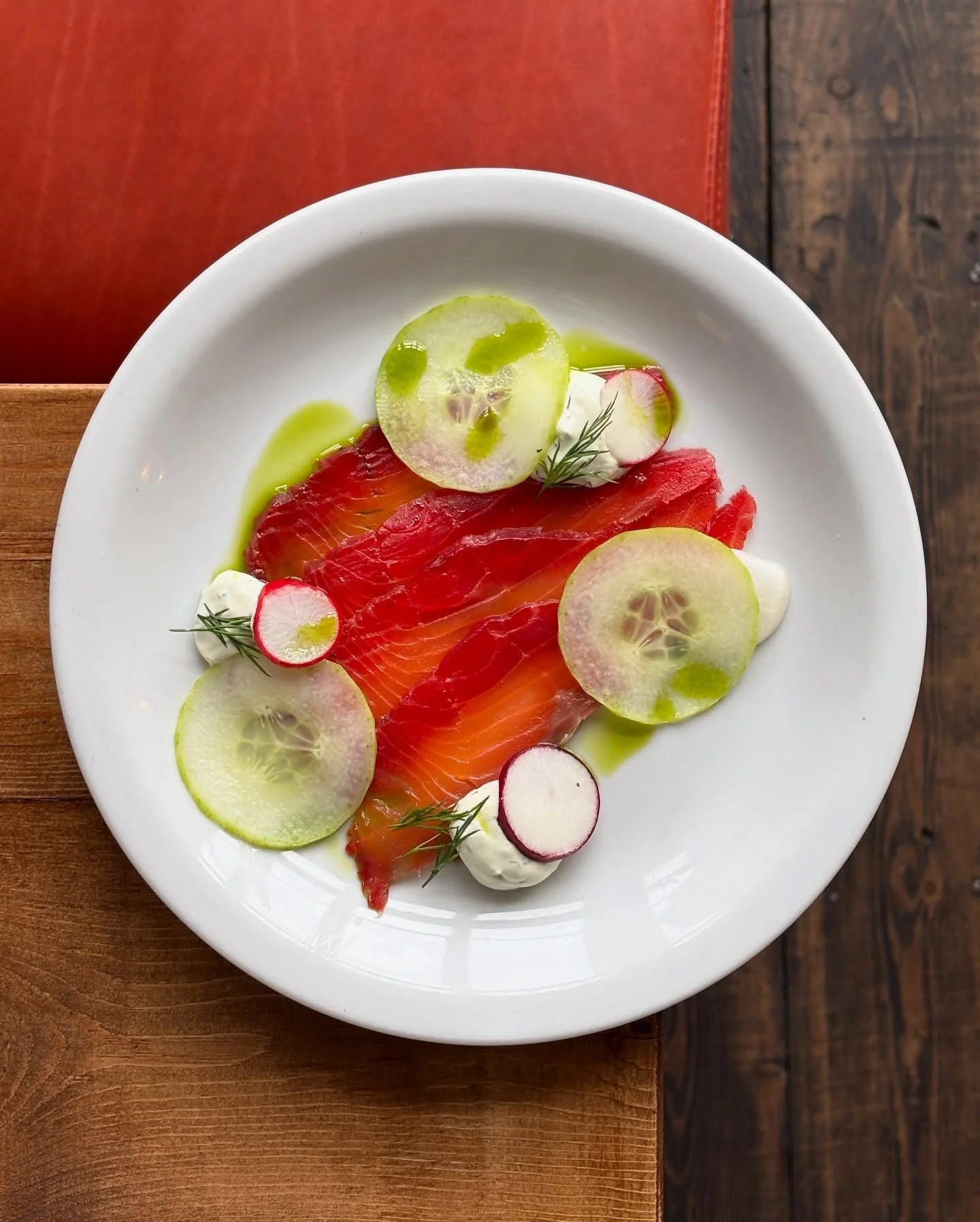 Home cured salmon crudo, dill cr&egrave;me fra&icirc;che, pickled cucumber, heritage radishes.