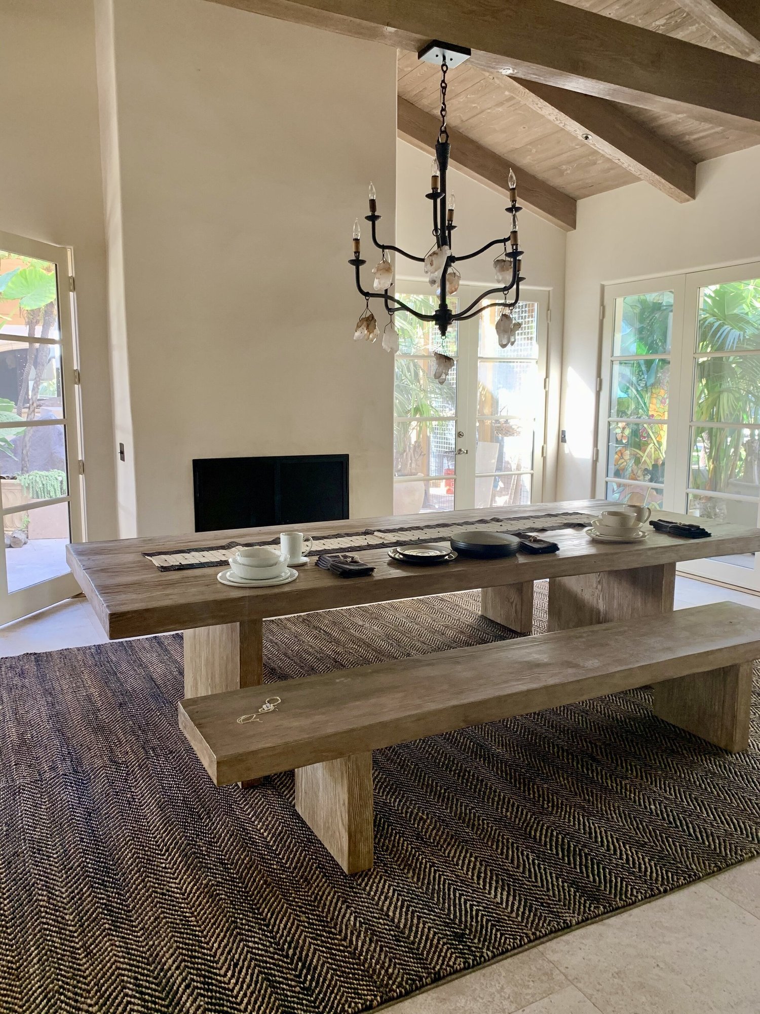 Rachael Goddard Design Studio Malibu Retreat table styling with cream ceramic bowls, woven runner, dark napkin, and organic luxury coastal design.