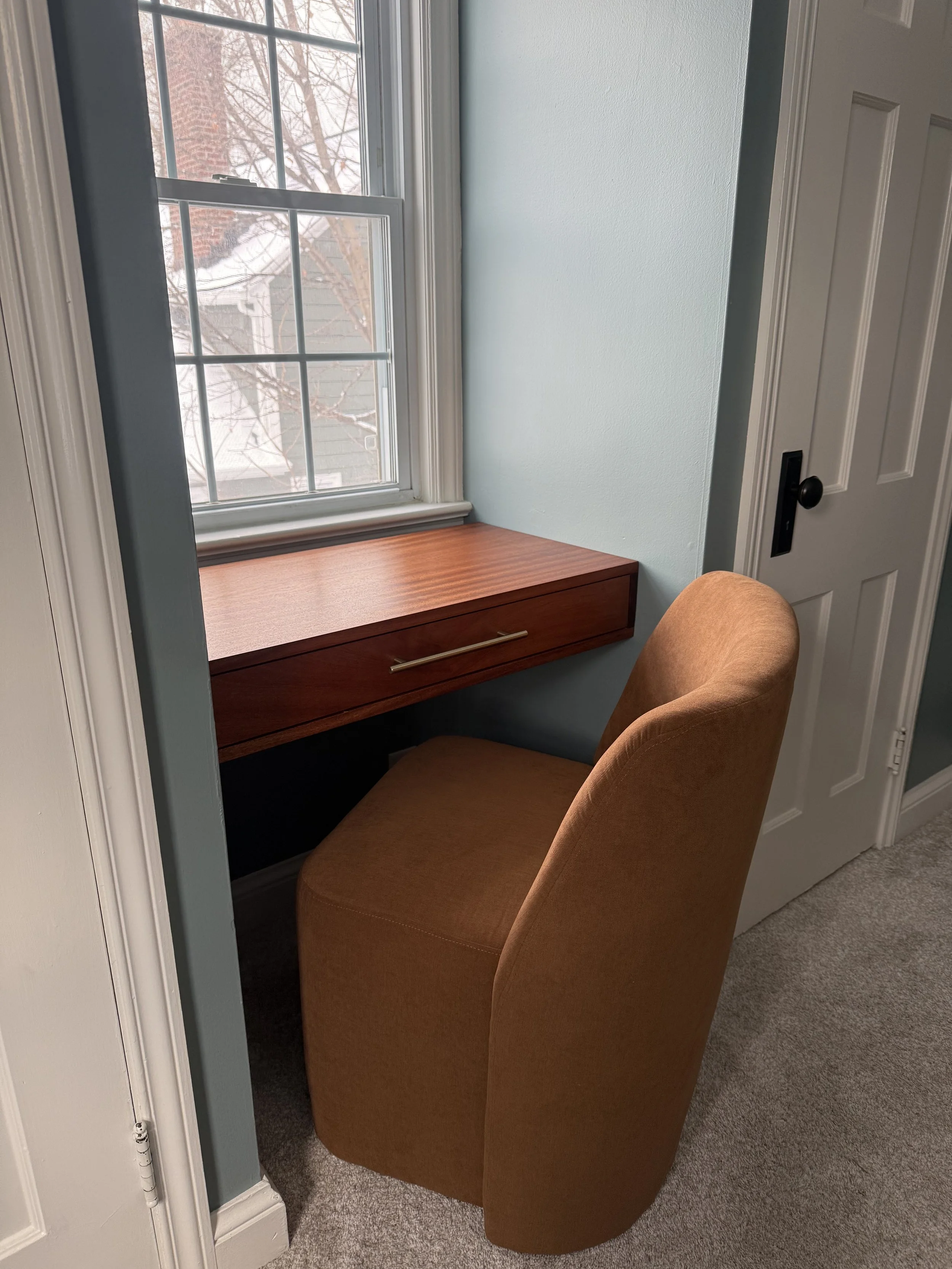 floating wood vanity desk built into window nook