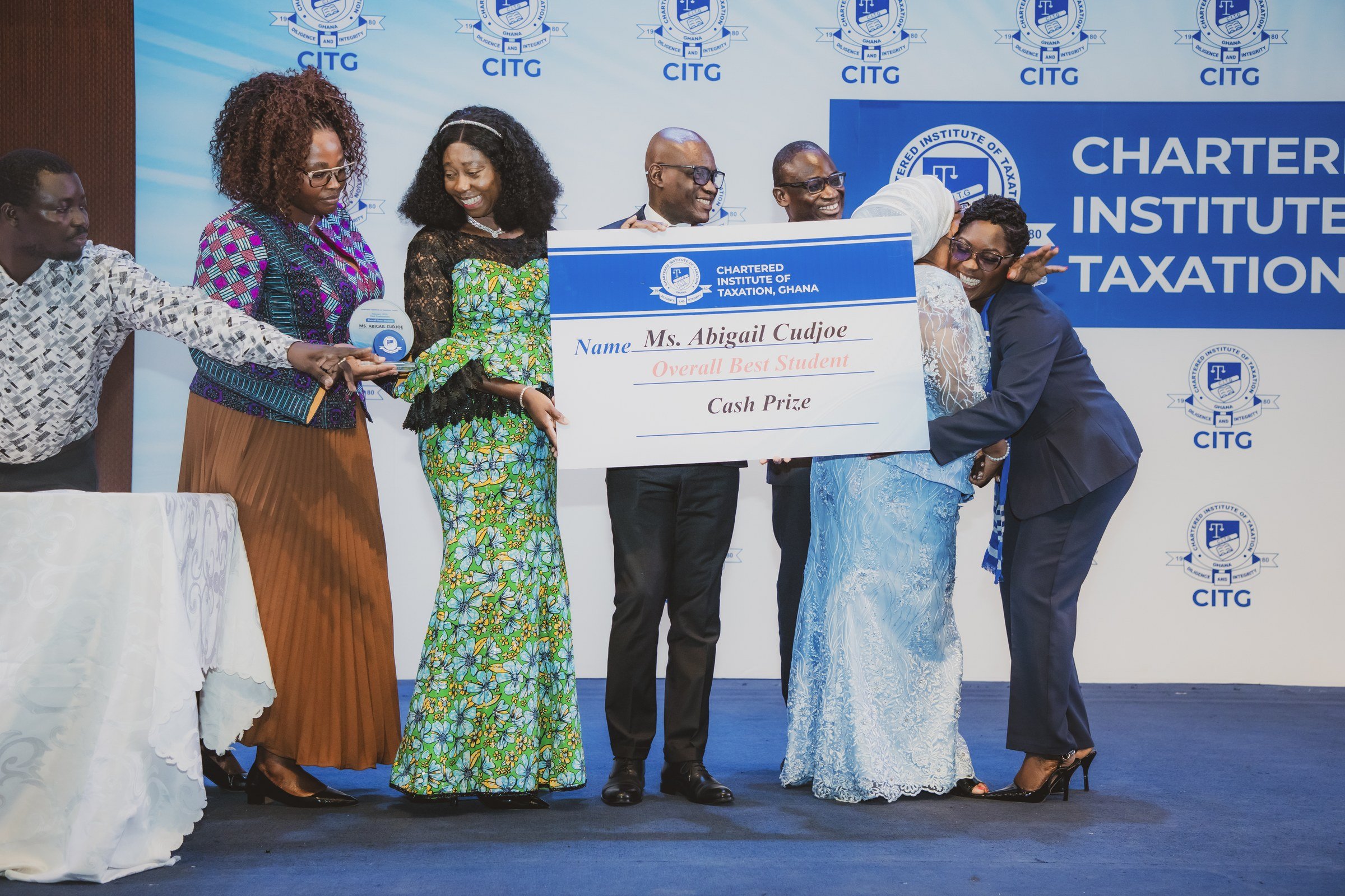 Group celebrating a prize presentation together on the CITG ceremony stage, CITG graduation, May 2026.
