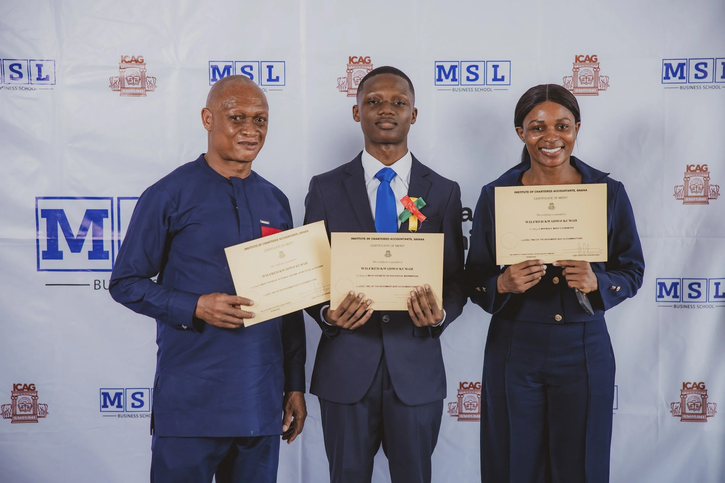 Three people displaying certificates together at the MSL and ICAG backdrop, ICAG graduation, February 2026.