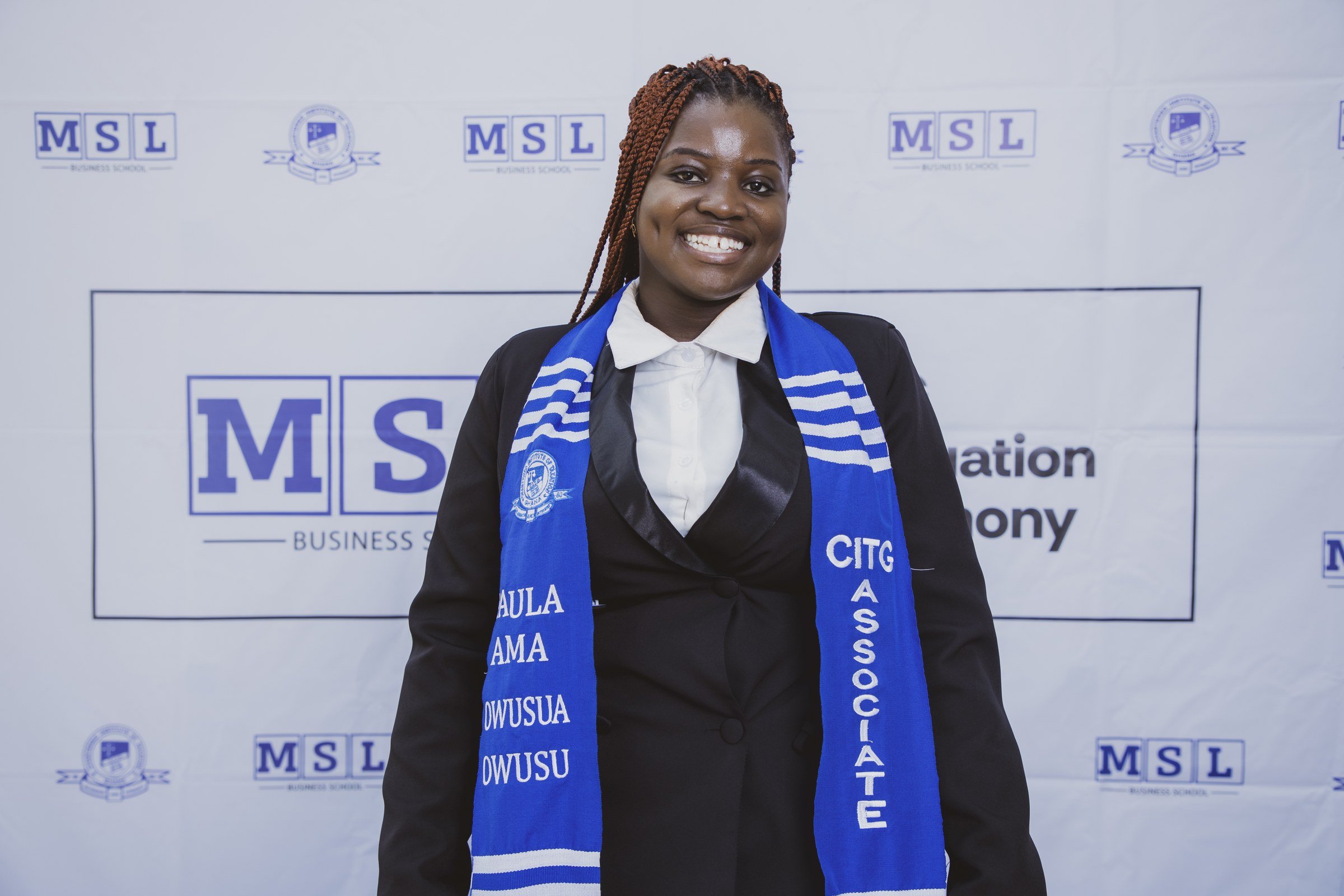 Smiling graduate with braided hair wearing a blue CITG stole and white bow collar, CITG graduation, May 2026.