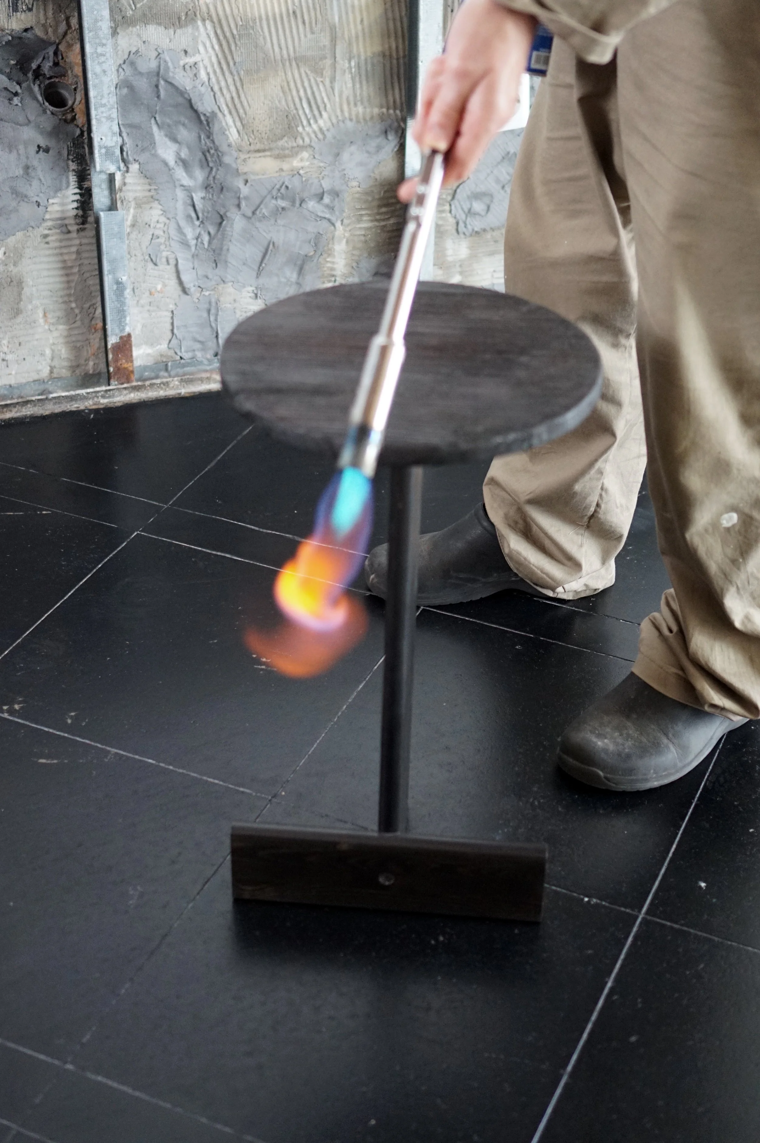 Close up burning process of the Otty side table by Leonhard Pfeifer