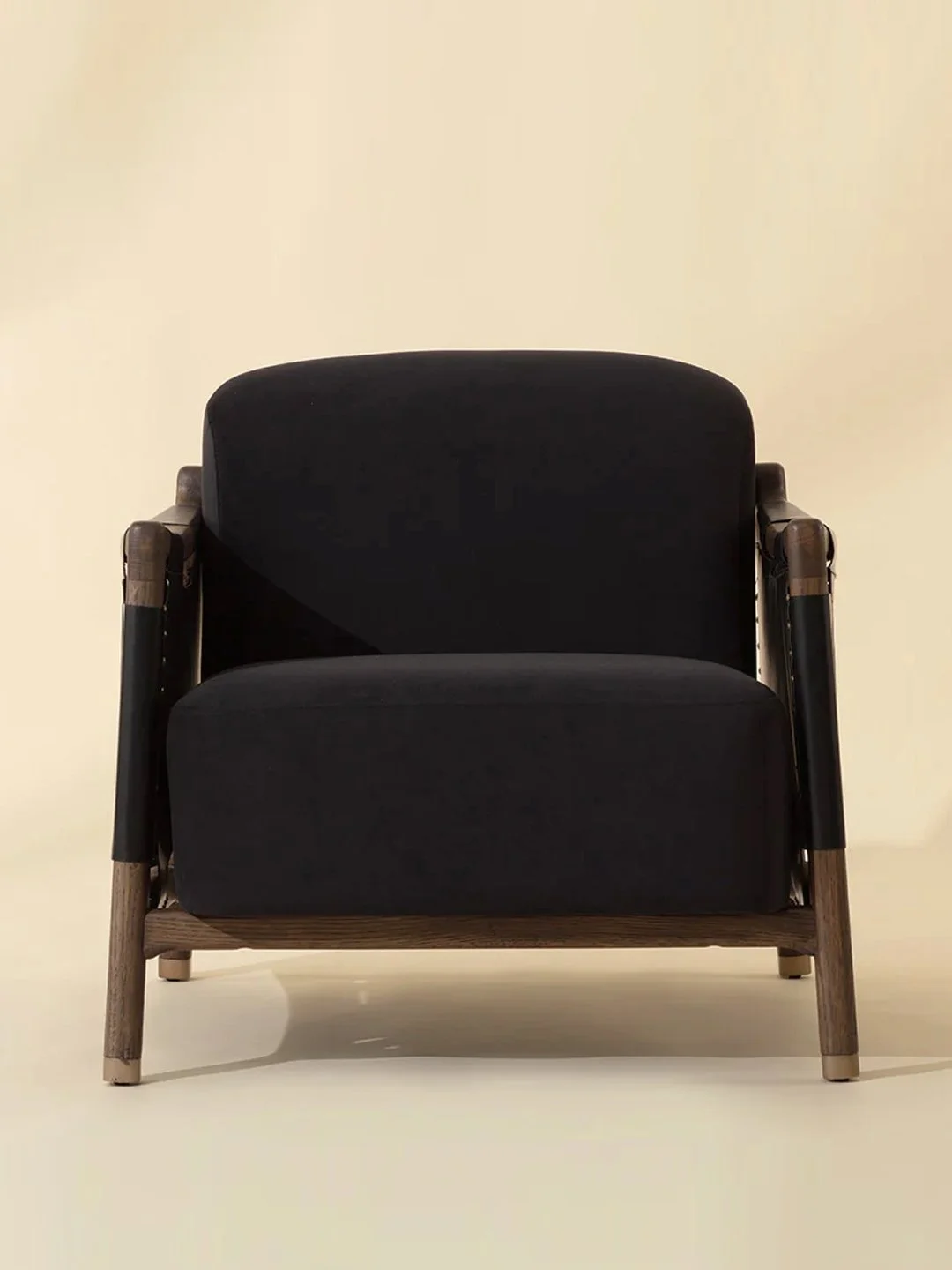 Modern chair in antique brown dark stained oak with black velvet fabric and black leather side panels and brass details