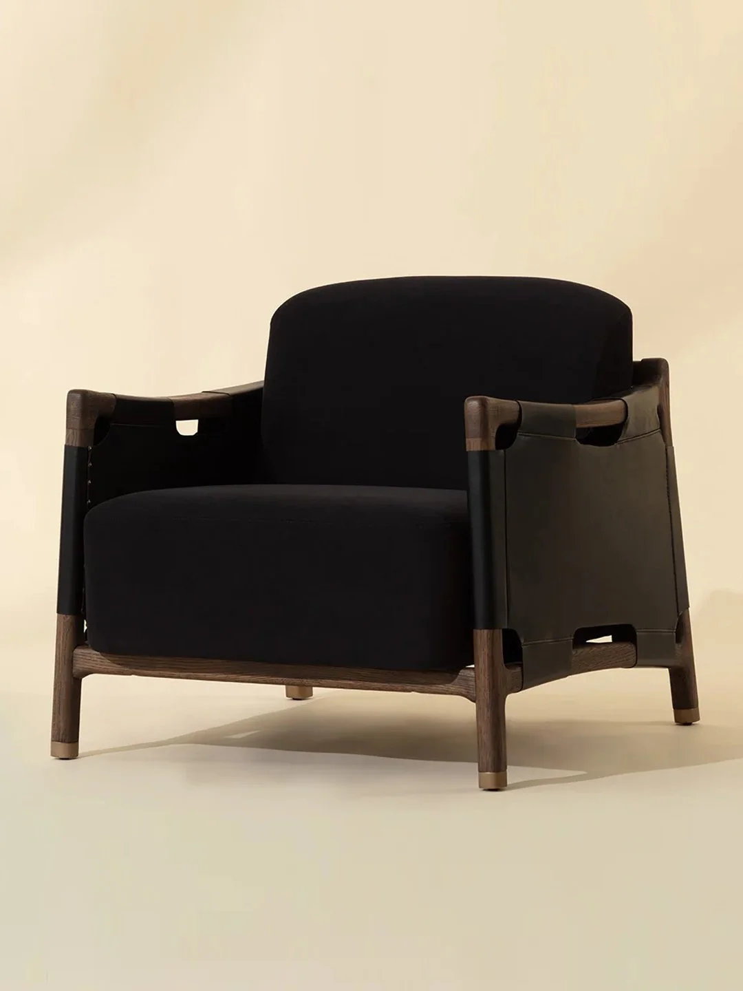 Modern chair in antique brown dark stained oak with black velvet fabric and black leather side panels and brass details