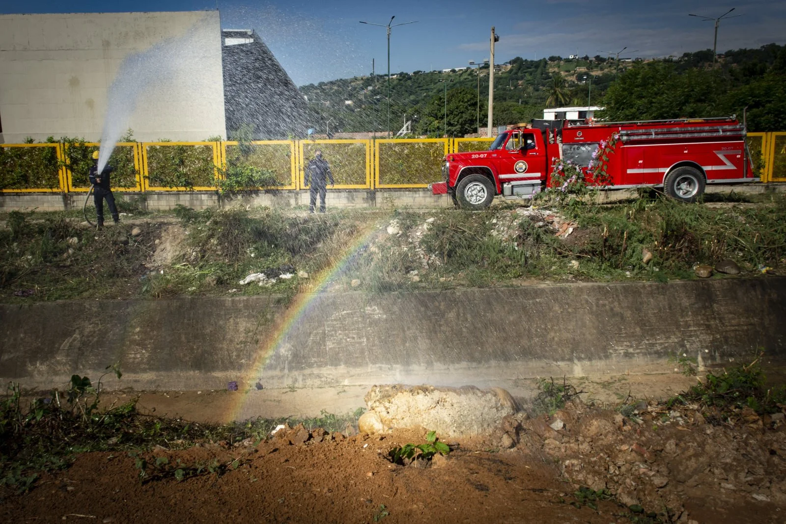 COLOMBIA 2020. Cúcuta municipal tree-planting campaign.

22 December 2020. Ciudadela El Progreso, Cúcuta, Norte de Santander, Colombia. A firefighter from Cúcuta's municipal fire service waters newly prepared planting beds during the city's "Un voto,