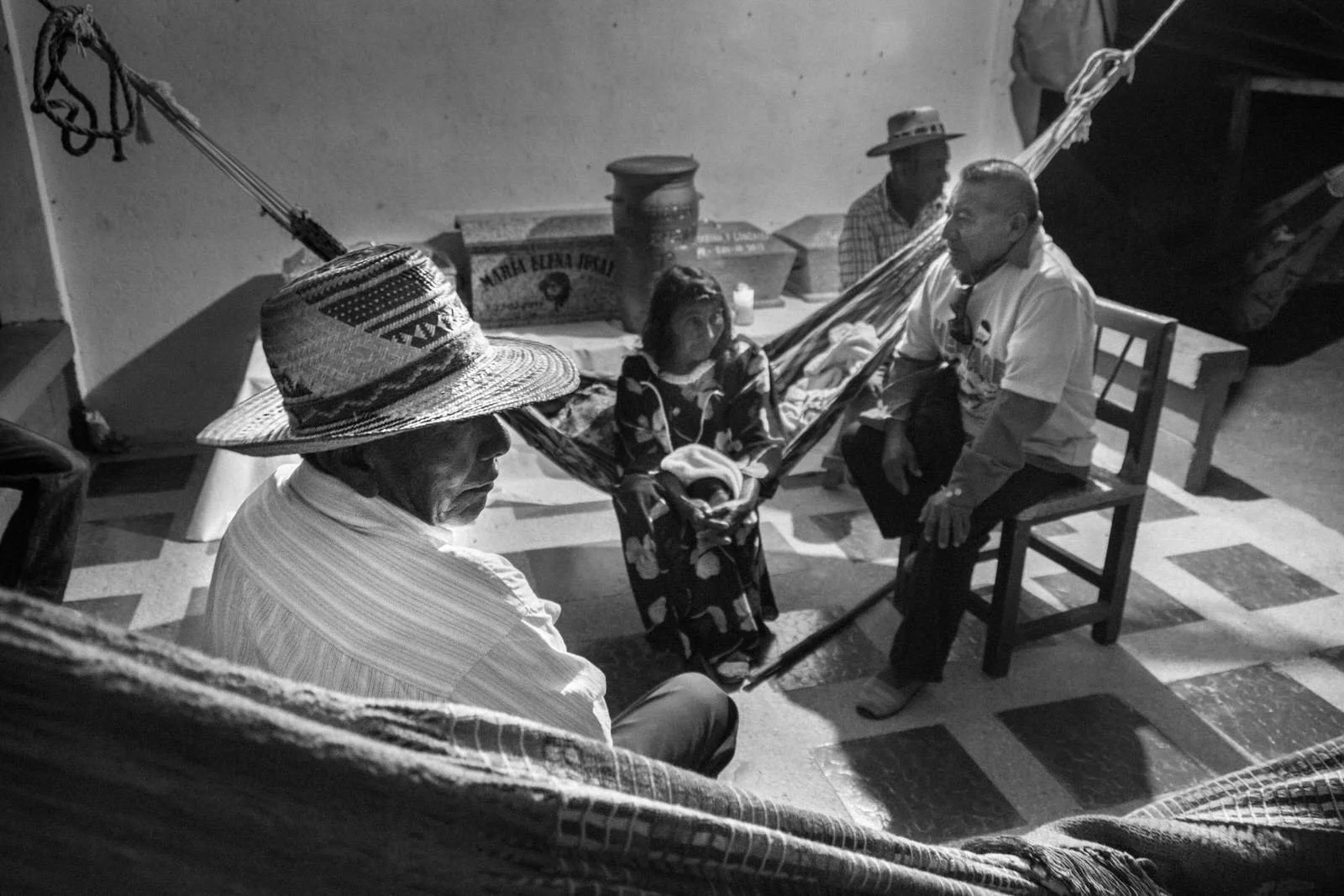 COLOMBIA 2017. Ritual vigil after an Ayulaa funeral in La Alta Guajira.
24 February 2017. Upper La Guajira, Colombia. A Wayuu woman sits in a hammock surrounded by family members who keep her awake throughout a three-day vigil following an Ayulaa fun