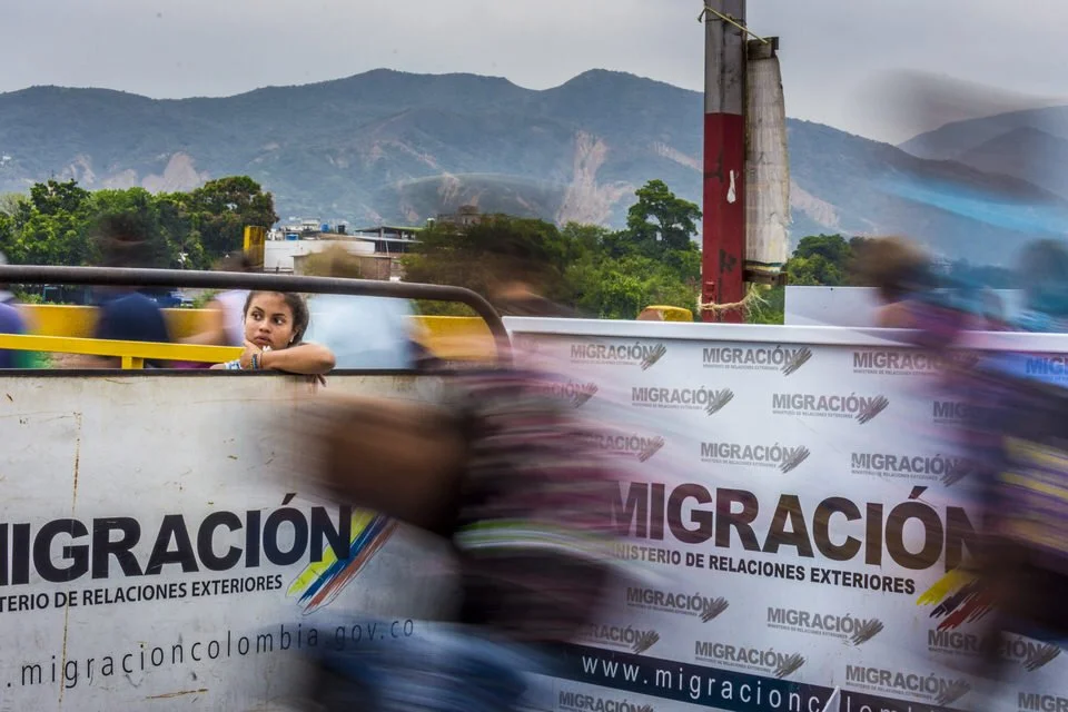 COLOMBIA 2018. Venezuelan migration crisis at the Simón Bolívar International Bridge.

18 April 2018. Simón Bolívar International Bridge, Cúcuta, Norte de Santander, Colombia. A young girl looks out from behind a security barrier as Venezuelan migran