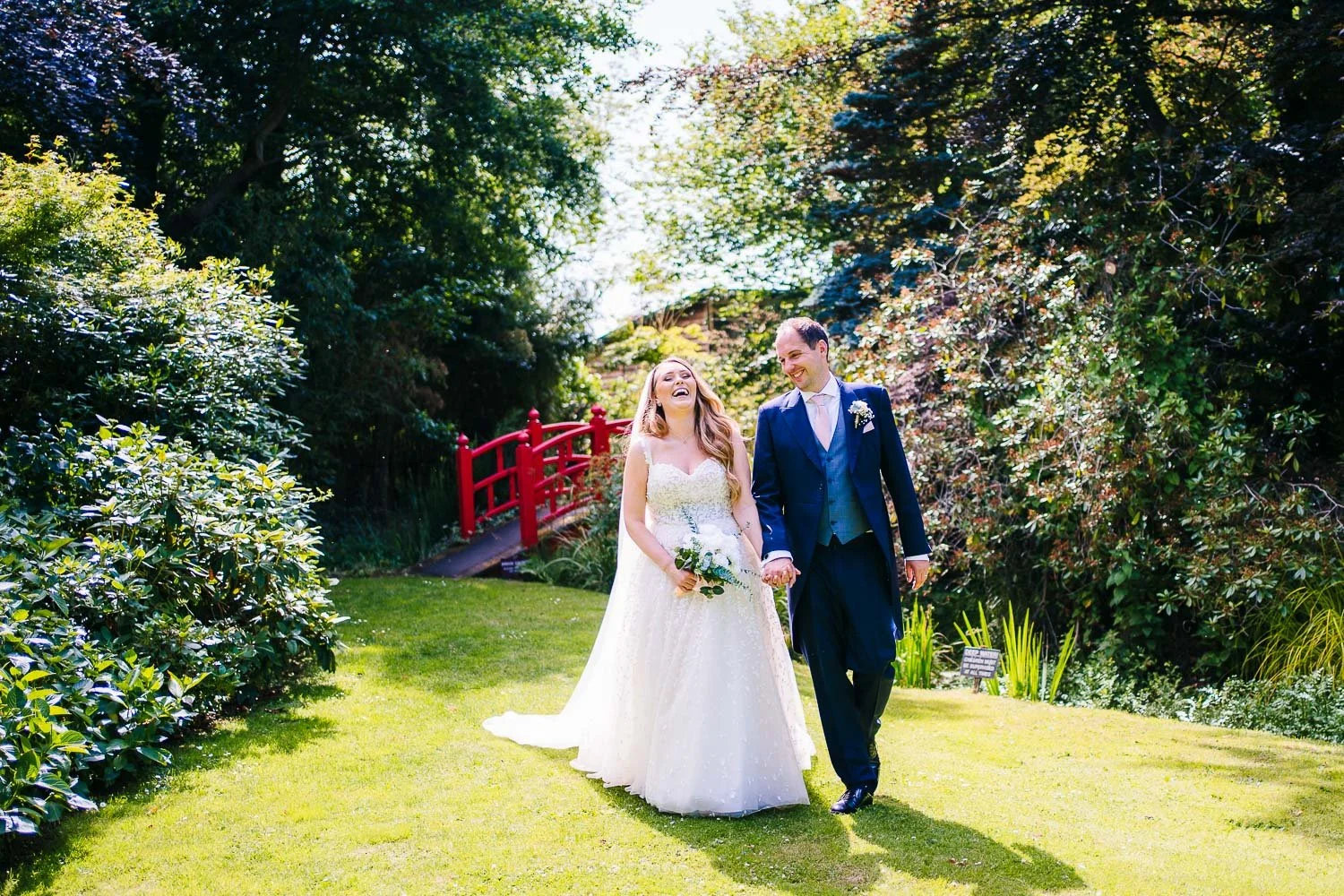 rivervale-barn-wedding-couple-laughing-whilst-walking.jpg